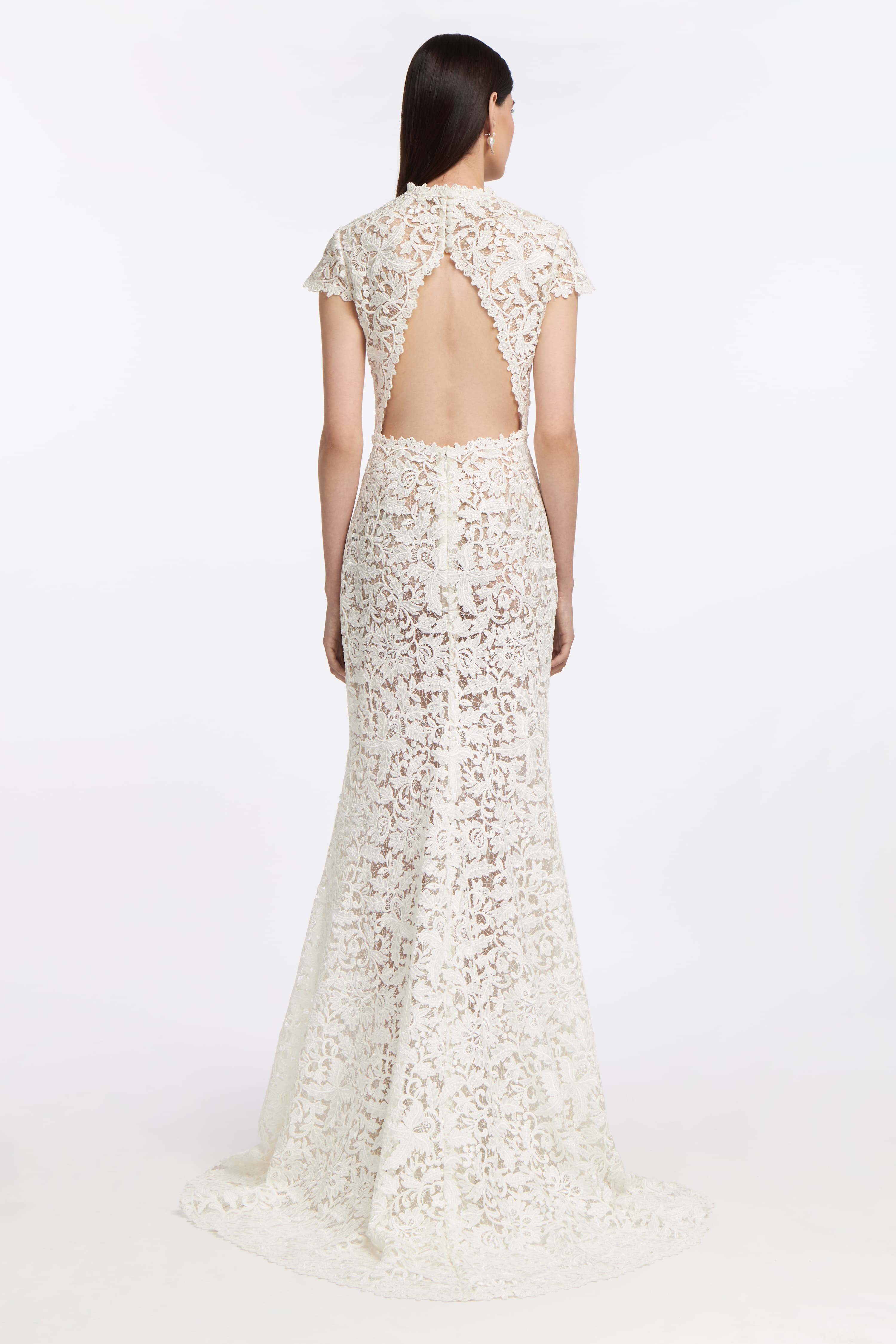 Back view of the Bia Corded Lace Gown showcasing an open-back design with scalloped lace edges and a flowing train. Ideal for a romantic wedding look.