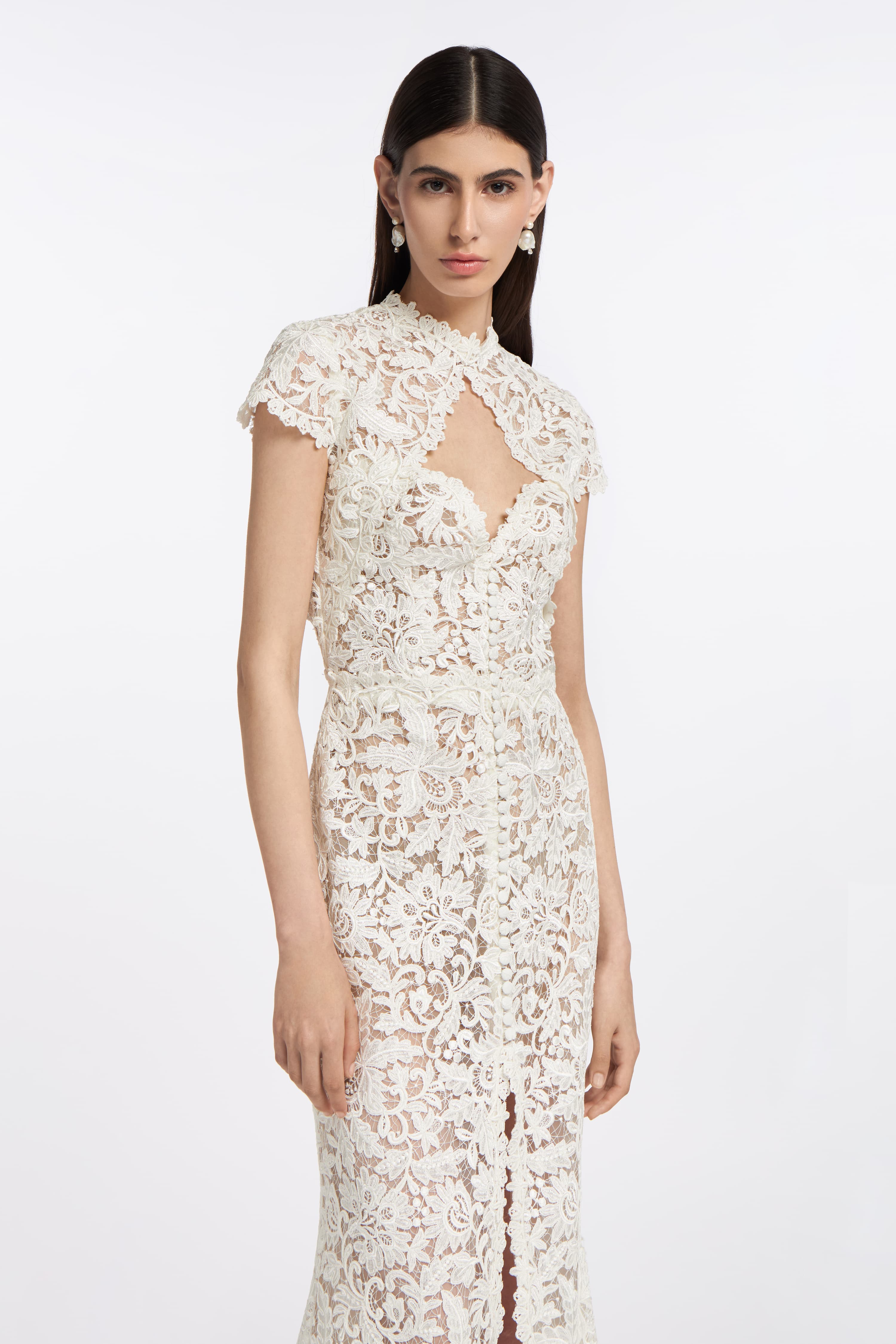 Elegant Bia Corded Lace Gown with delicate cap sleeves, a keyhole neckline, and floral lace patterns. A sophisticated choice for modern brides.