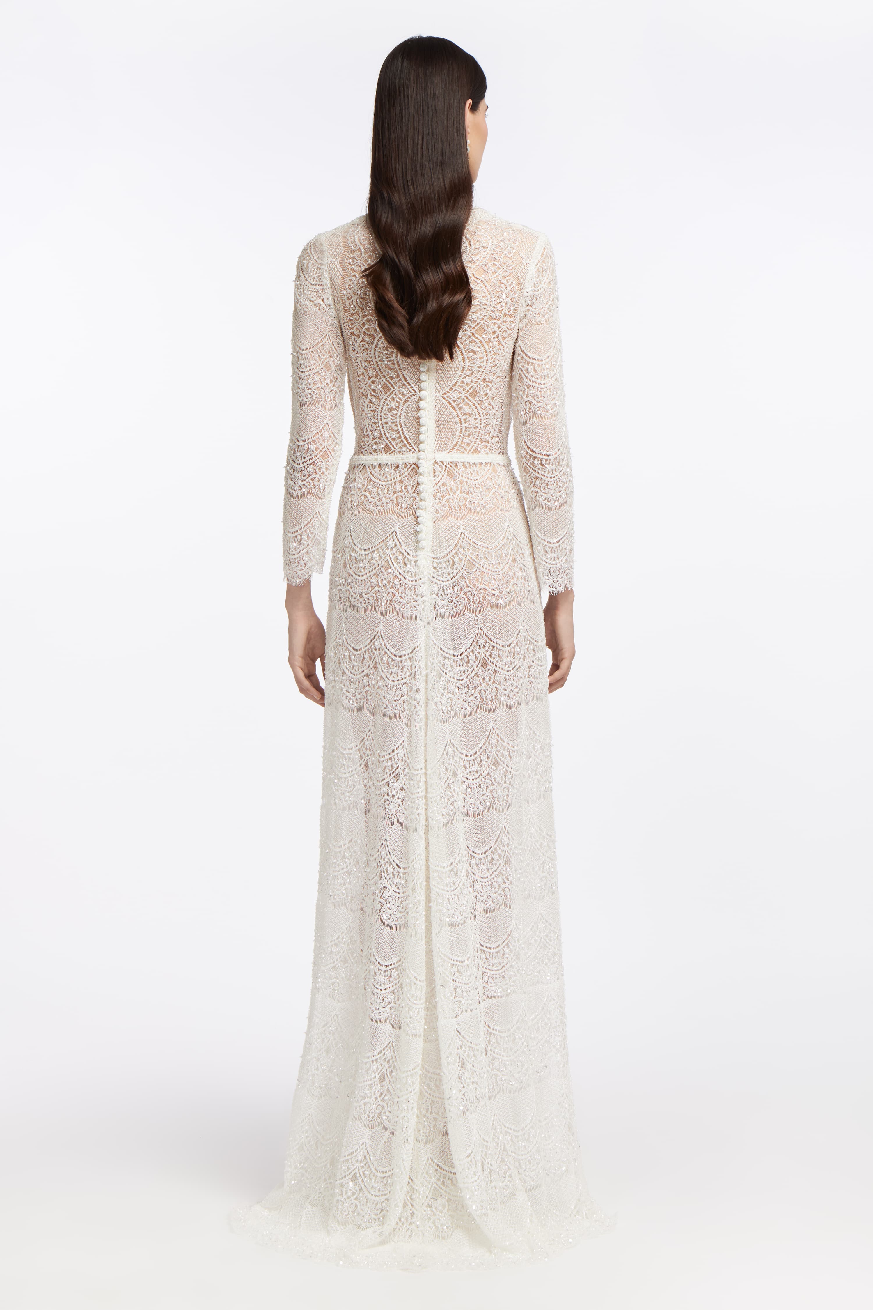 Back view of Minthe Beaded French Lace Gown with intricate lacework, long sleeves, and a flowing silhouette. A timeless wedding dress for modern brides.