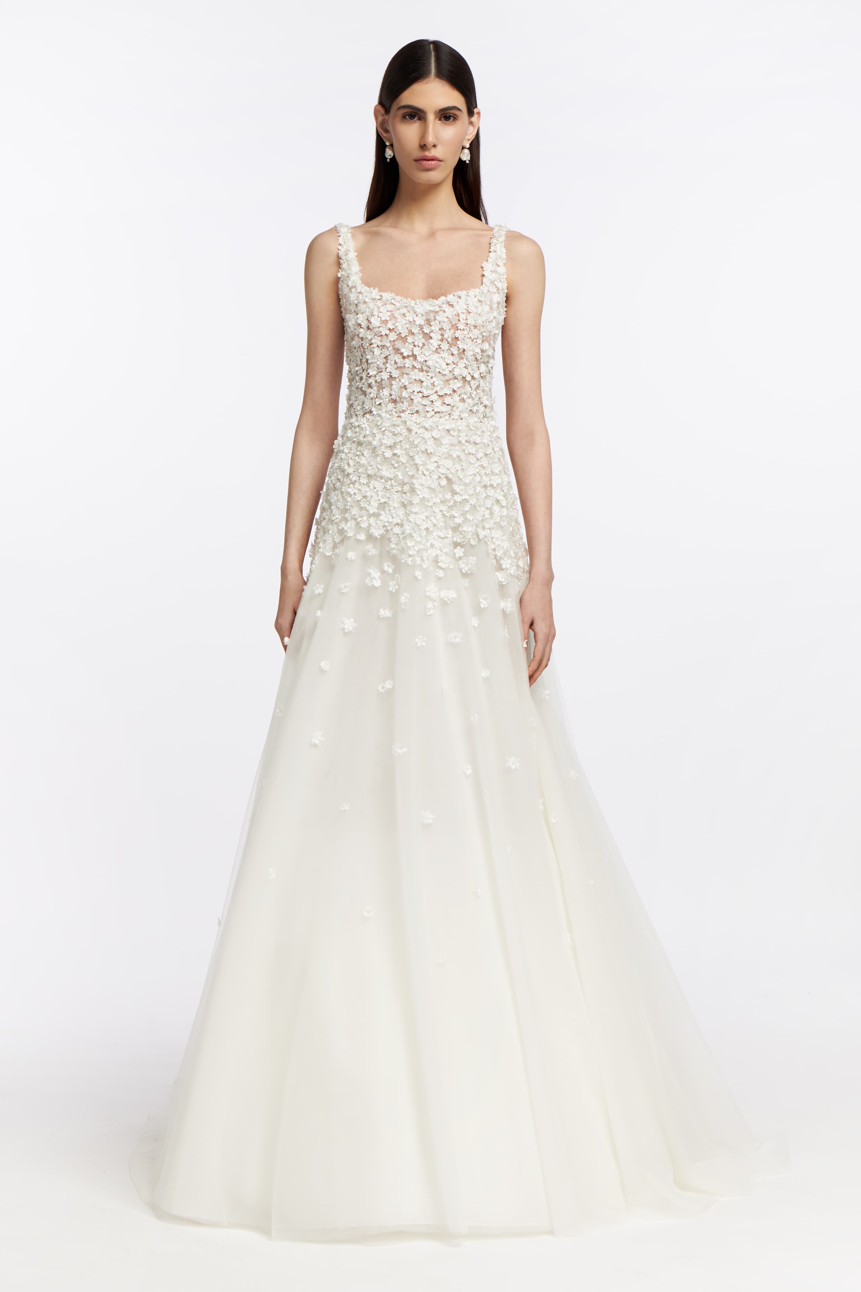 Hestia French Tulle Gown featuring delicate floral appliqués and a flowing A-line skirt. Perfect for a romantic bridal look in Spring 2025.