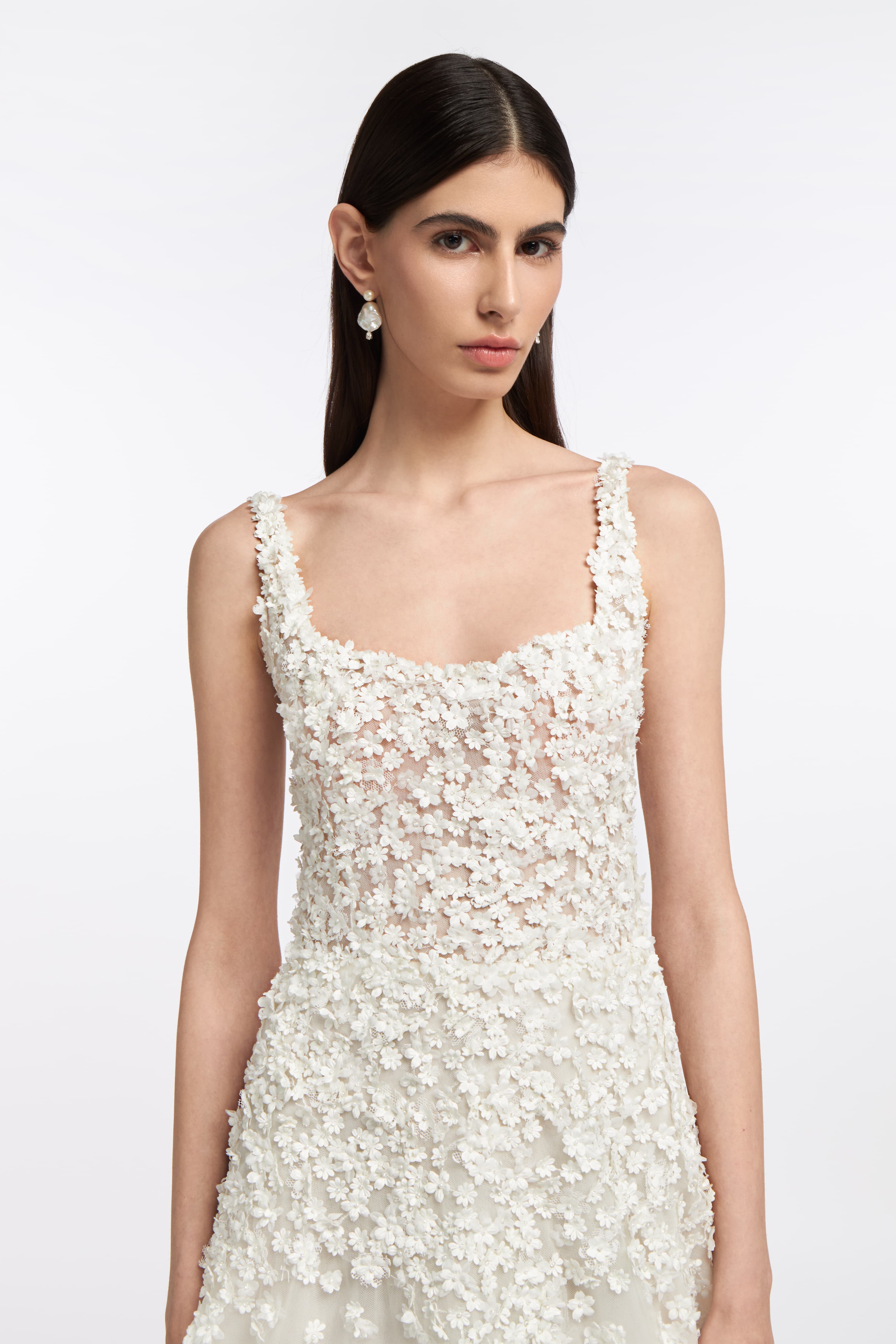 Close-up of the Hestia French Tulle Gown showcasing intricate floral lace detailing on the bodice. A stunning choice for modern brides.