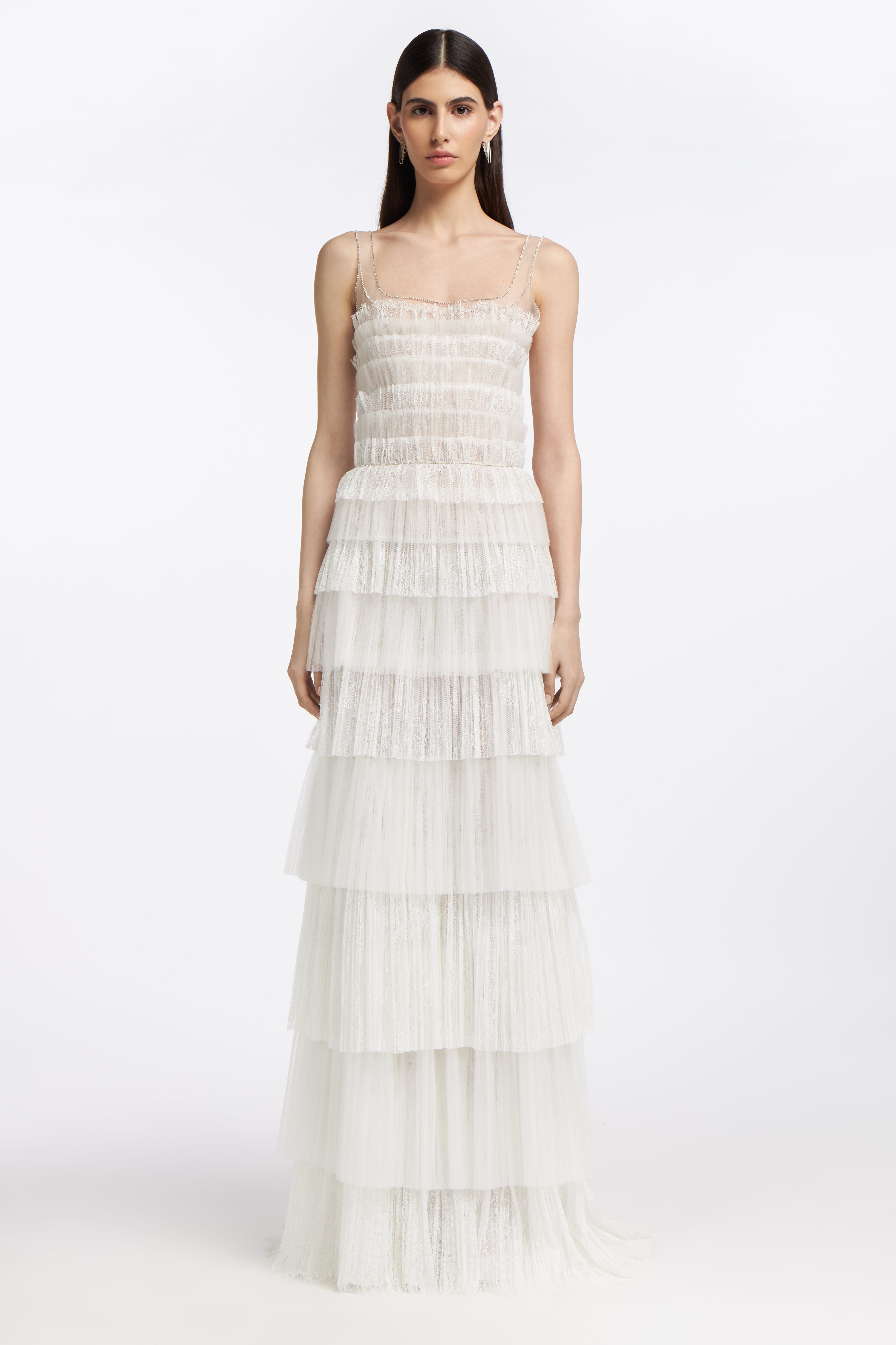 Galatea Plissé Lace Gown featuring tiered pleated lace and tulle layers, delicate spaghetti straps, and a fitted bodice for a romantic bridal look.