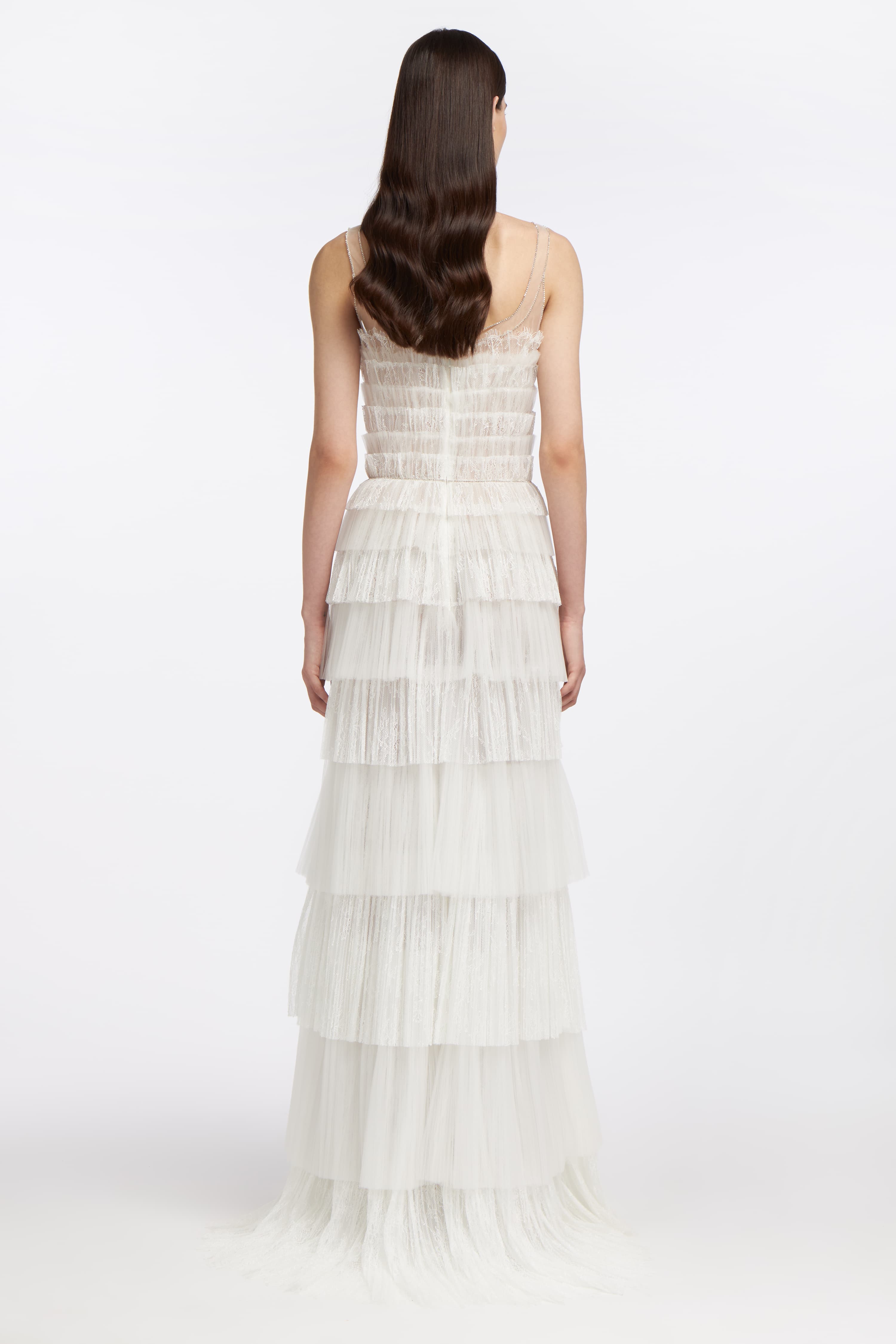 Back view of the Galatea Plissé Lace Gown highlighting cascading pleated lace tiers, sheer detailing, and a fitted silhouette for an elegant wedding dress design.
