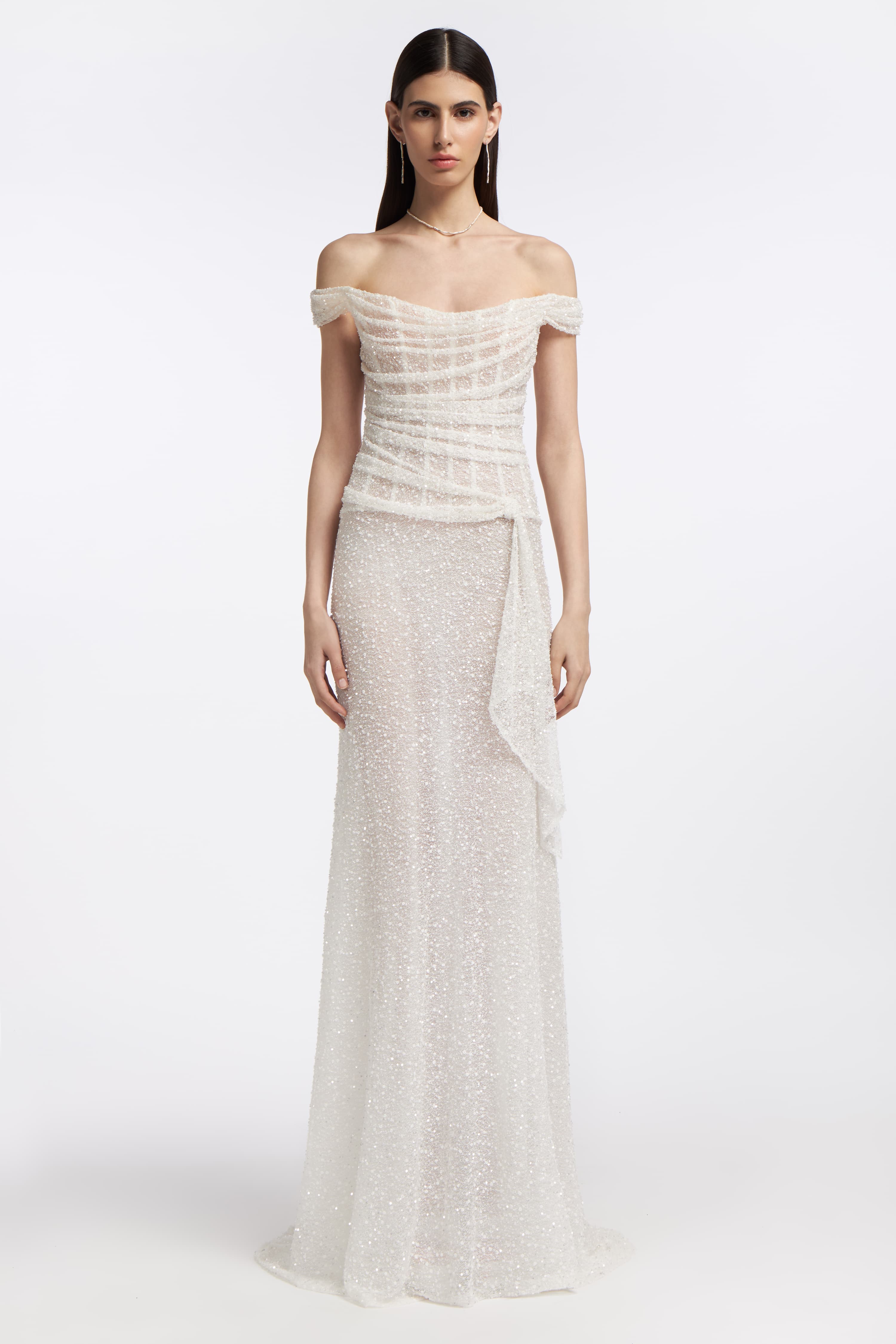Clio Beaded Draped Gown featuring an off-the-shoulder neckline, intricate beadwork, and a flowing silhouette. Perfect for bridal elegance in Spring 2025.