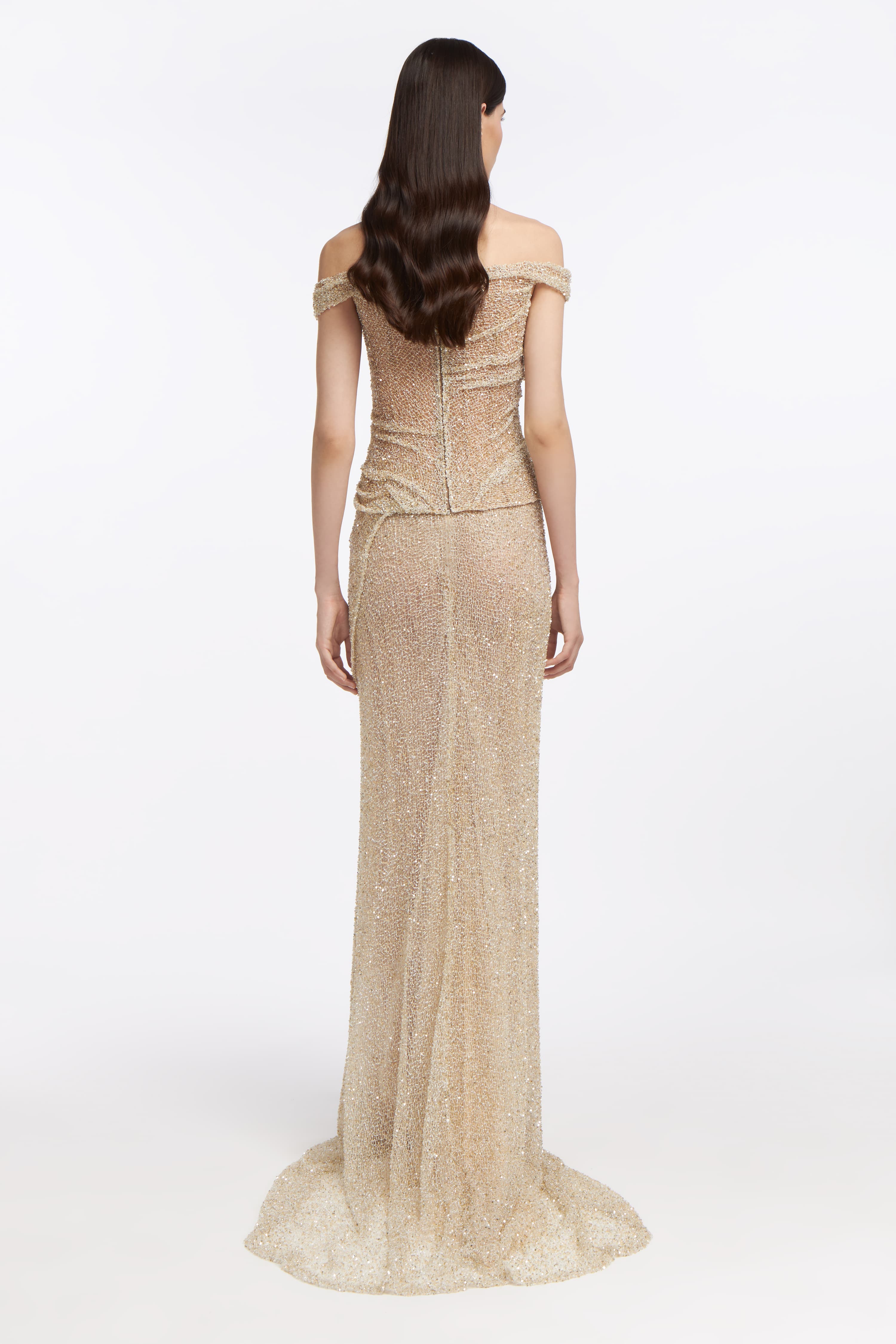 Back view of the Calypso Beaded Gown with a fitted silhouette, shimmering beadwork, and a flowing train. A glamorous wedding dress for modern brides.