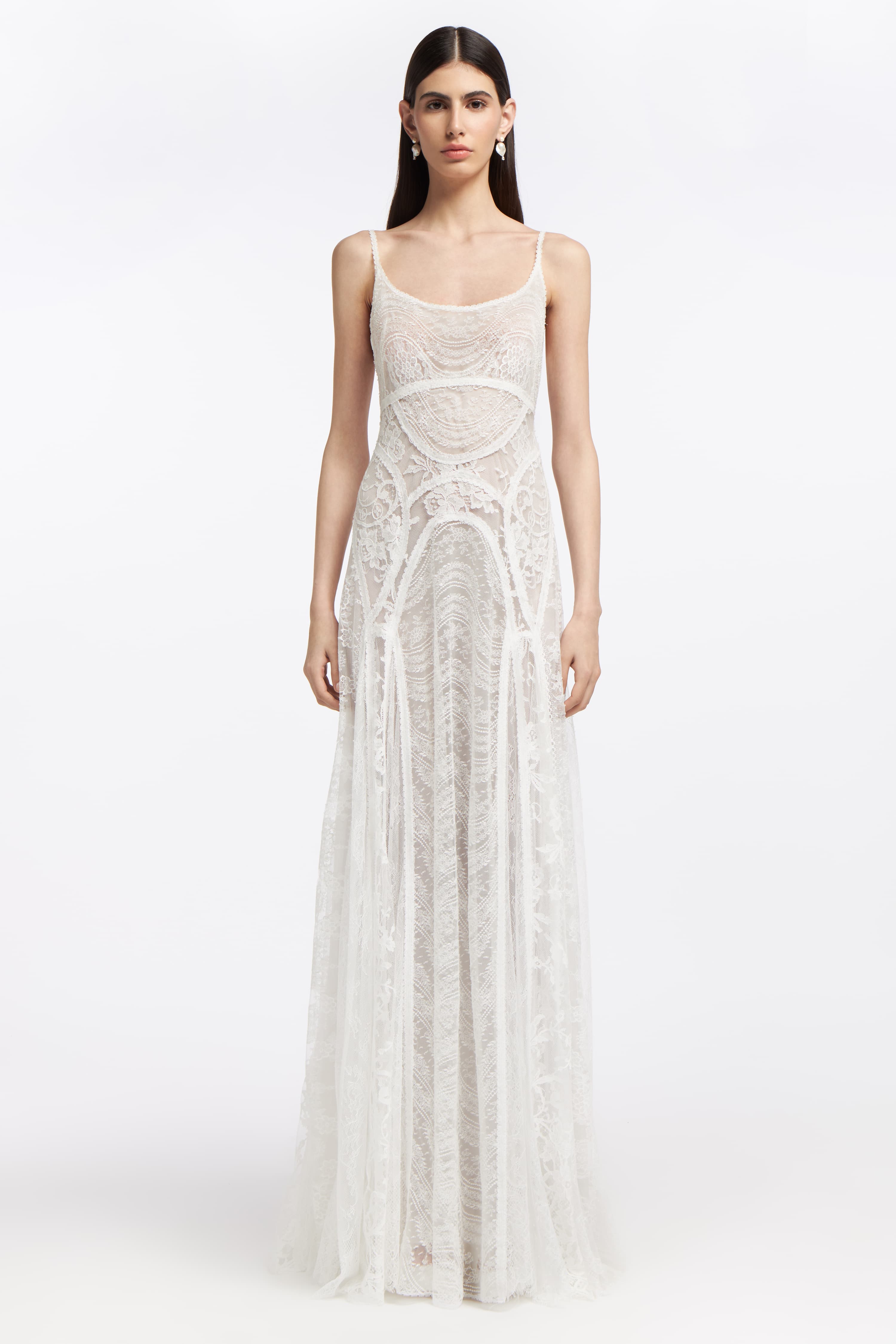 Ourania French Lace Gown featuring intricate lace detailing, a fitted bodice, and a flowing silhouette. Perfect for Bridal Spring 2025.