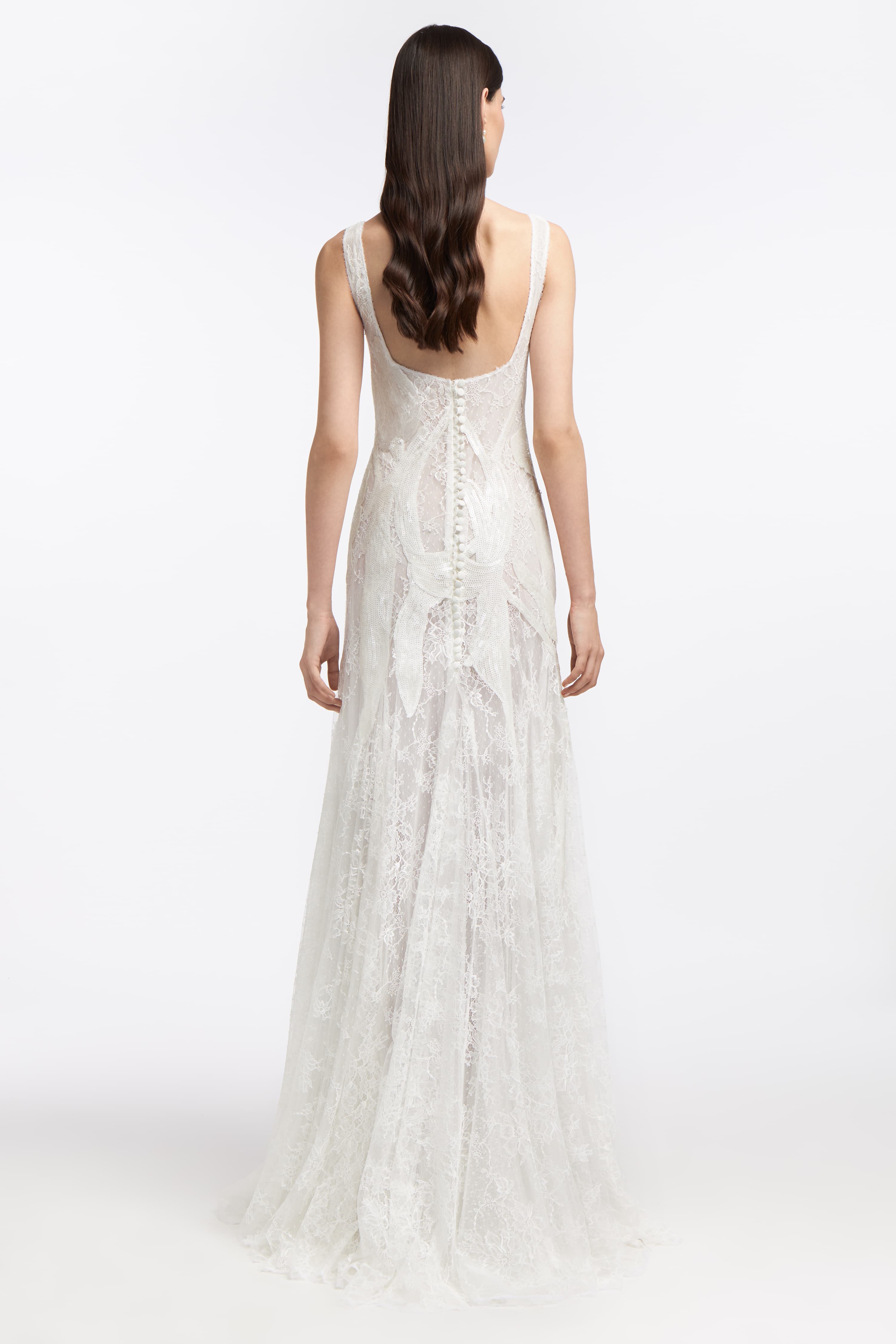 Back view of the Eudora Chantilly Lace Gown with a low scoop back, button detailing, and flowing lace train, ideal for a romantic wedding ensemble.