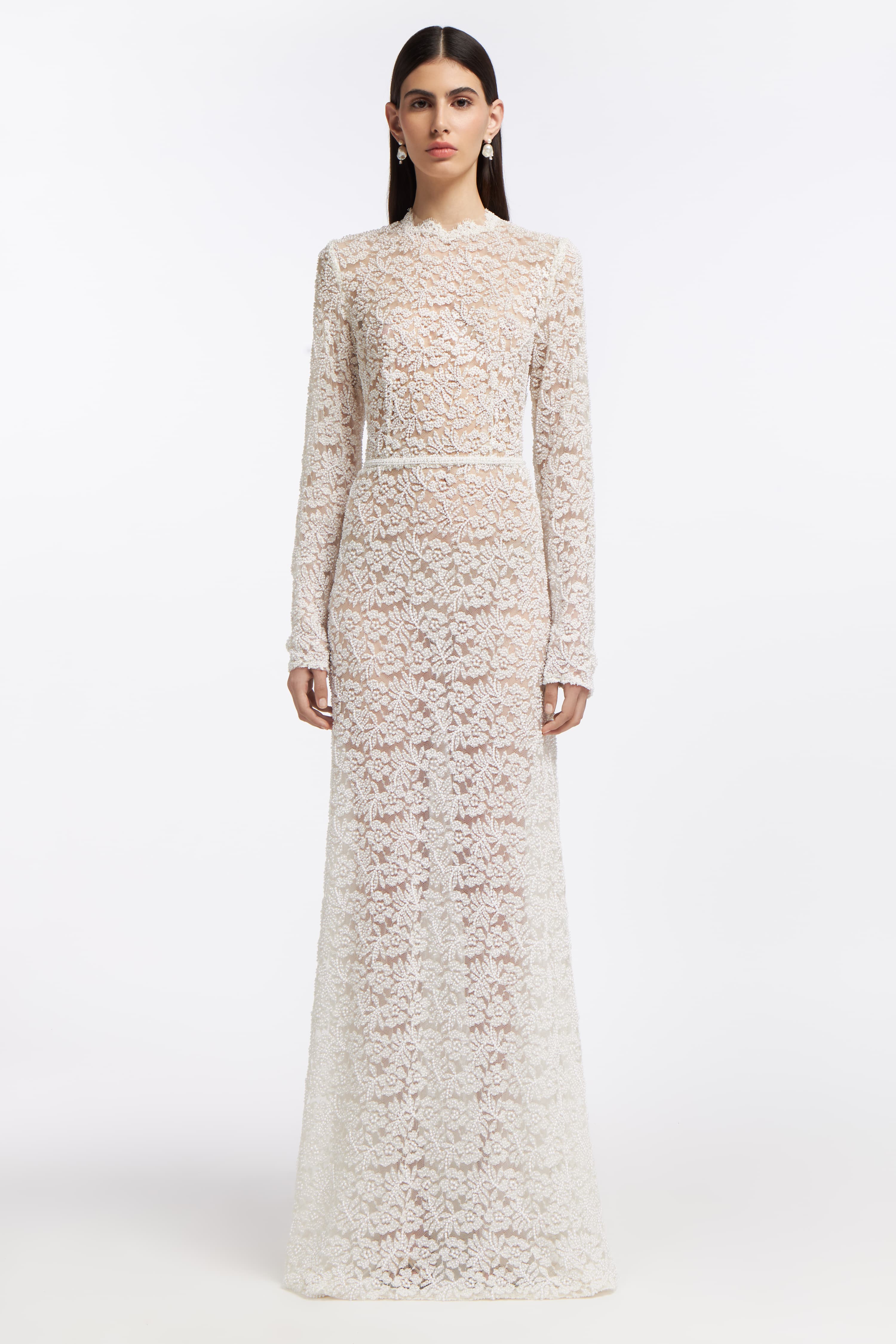 Rhodea Beaded Open-Back Gown featuring intricate lace detailing, long sleeves, and a floor-length silhouette. A timeless bridal dress for Spring 2025.