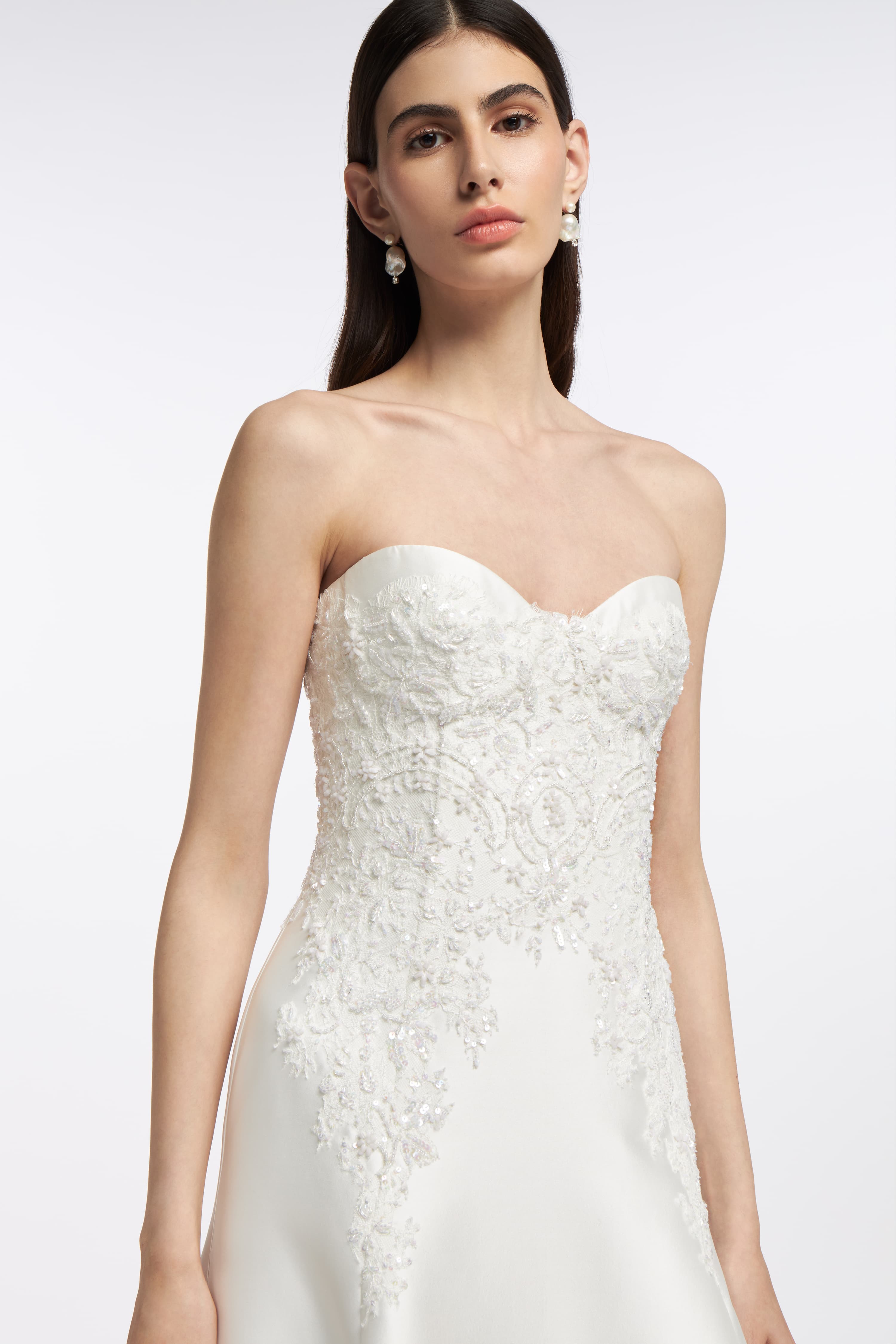 Close-up of the Eris Mikado Bustier Gown showcasing delicate lace embroidery on the structured bodice with a sweetheart neckline.