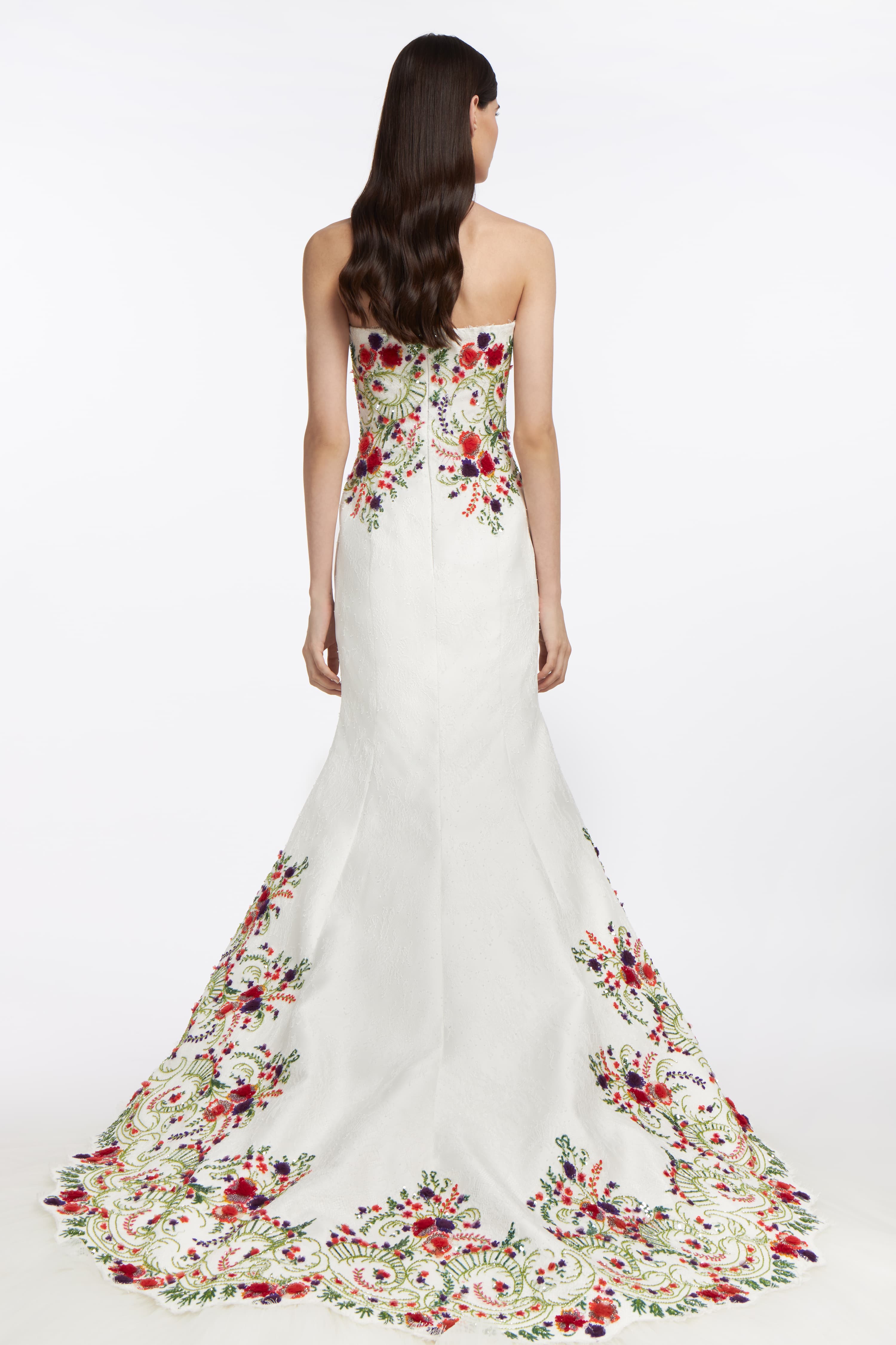 Back view of the Melinoë Chantilly Lace Gown, highlighting the embroidered lace details, fitted silhouette, and flowing mermaid train.
