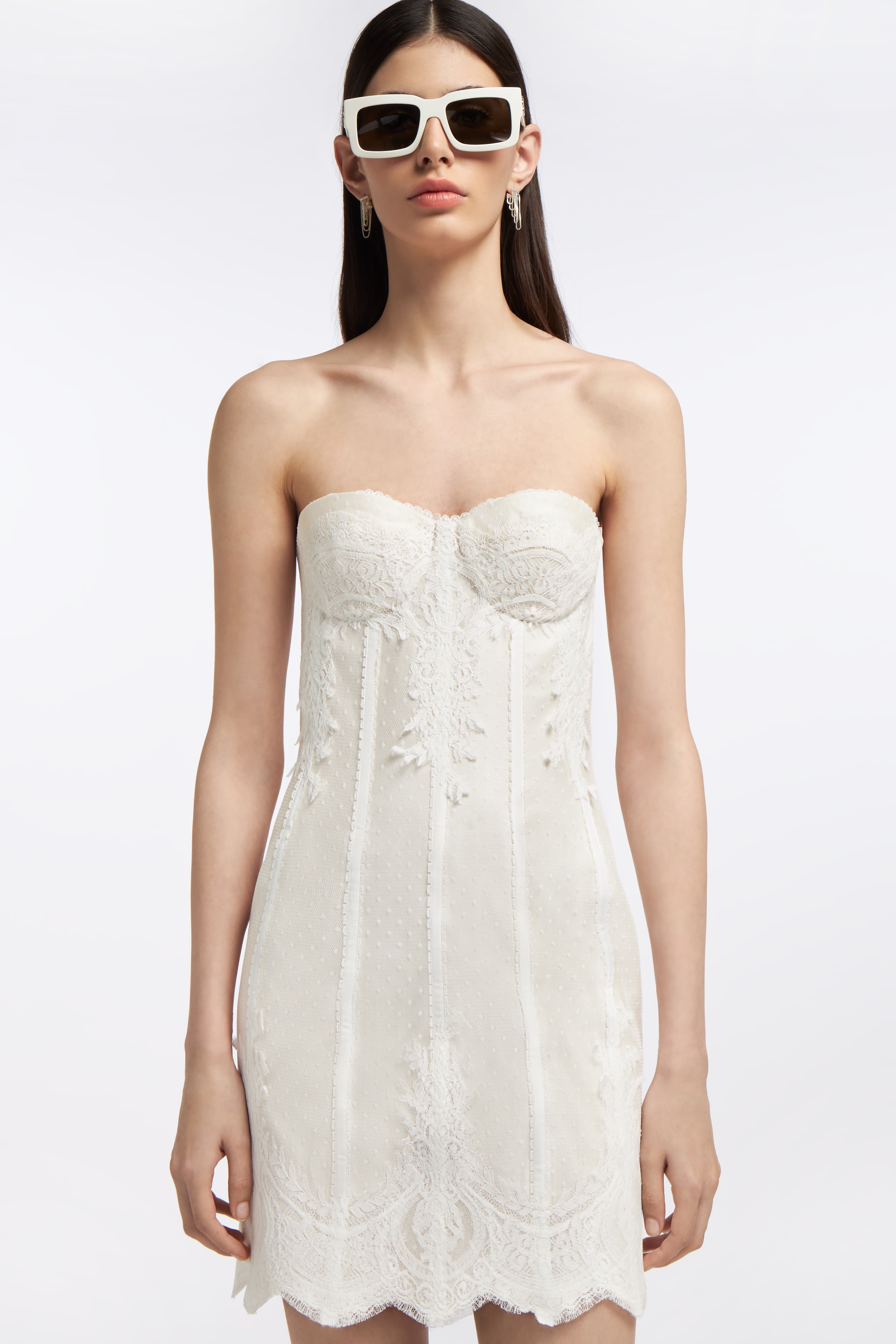 Close-up of the Melite French Tulle Bustier Mini Dress showcasing intricate lace embroidery, structured bodice, and a romantic strapless design.