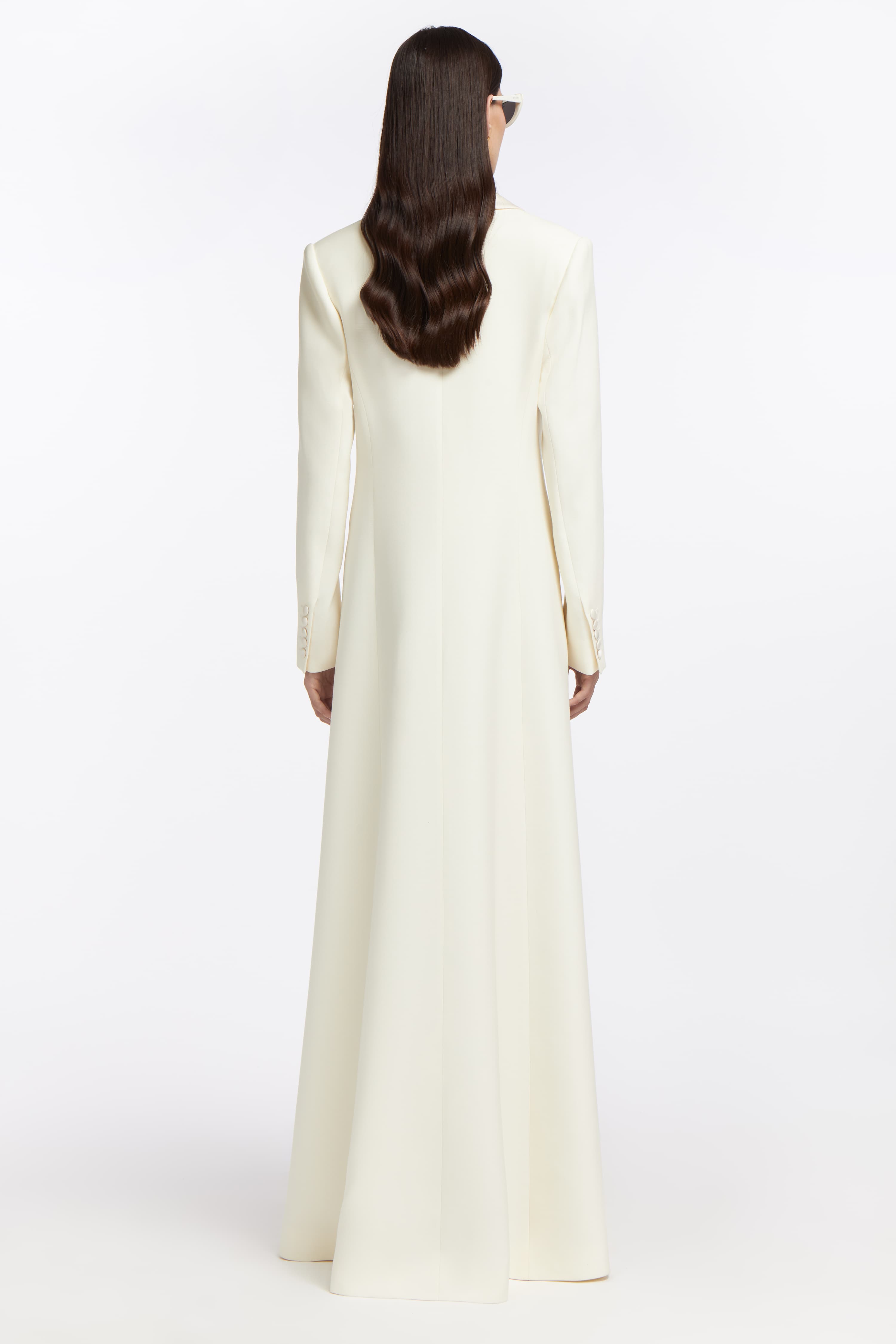 Back view of the Gaia Silk-blend Wool Coat, featuring a long, flowing bridal silhouette with a seamless finish, perfect for modern wedding elegance.