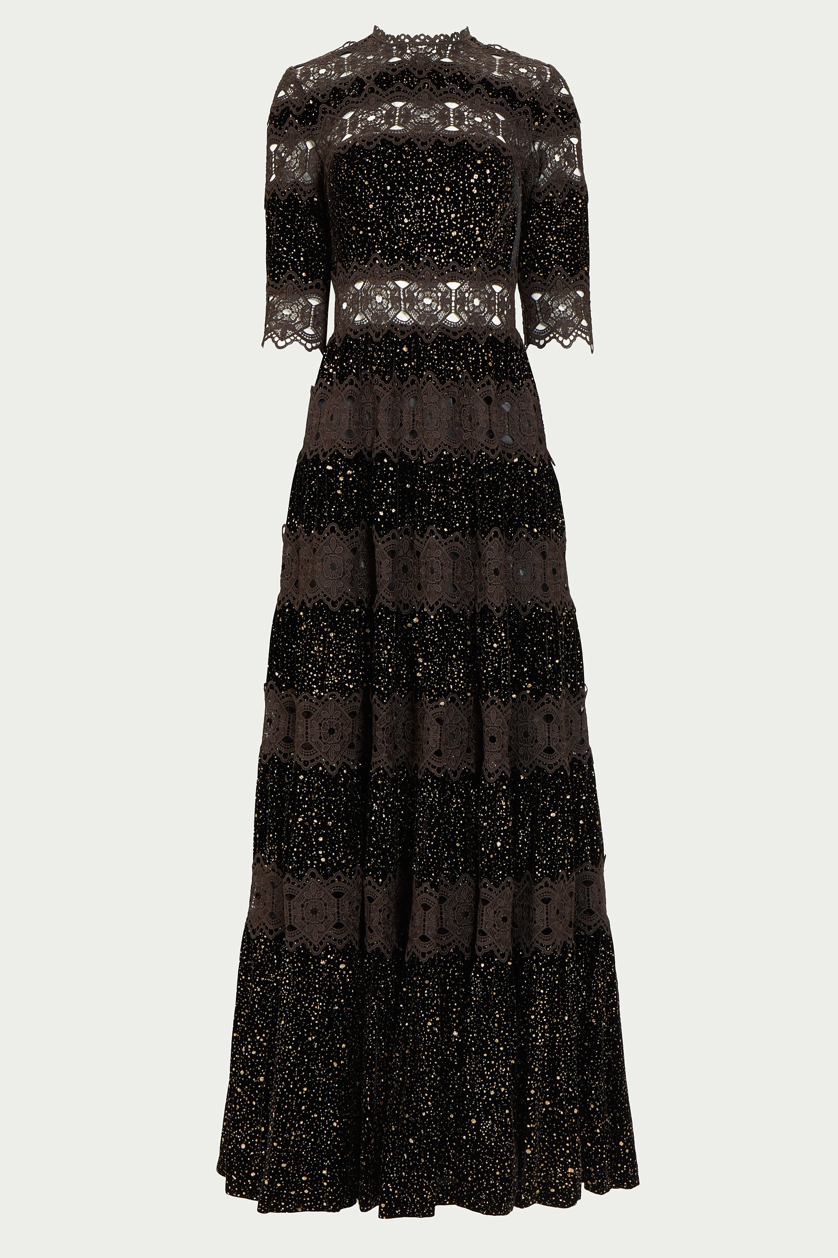 Black Costarellos evening gown with tiers of lace and shimmering opaque fabric. The dress features a high neckline and elbow length sleeves.