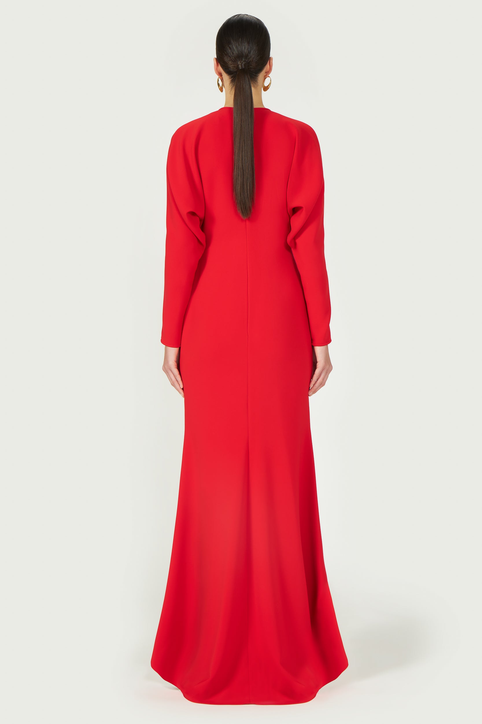 Back view of the Marlette High-Low Crepe Gown featuring a sleek silhouette and flowing high-low hemline for a graceful finish.