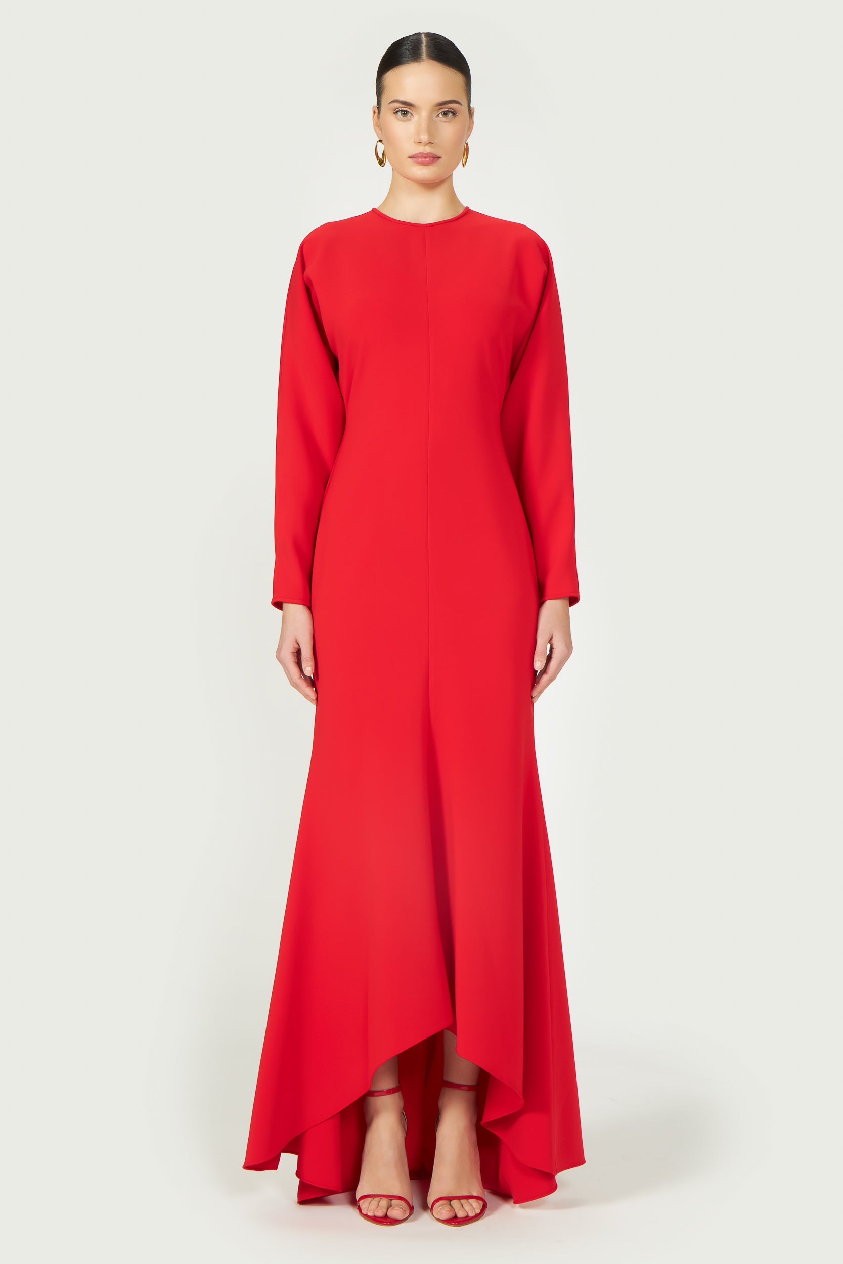 Marlette High-Low Crepe Gown in bold red with long sleeves and an elegant asymmetrical hemline. A sophisticated choice for formal occasions.