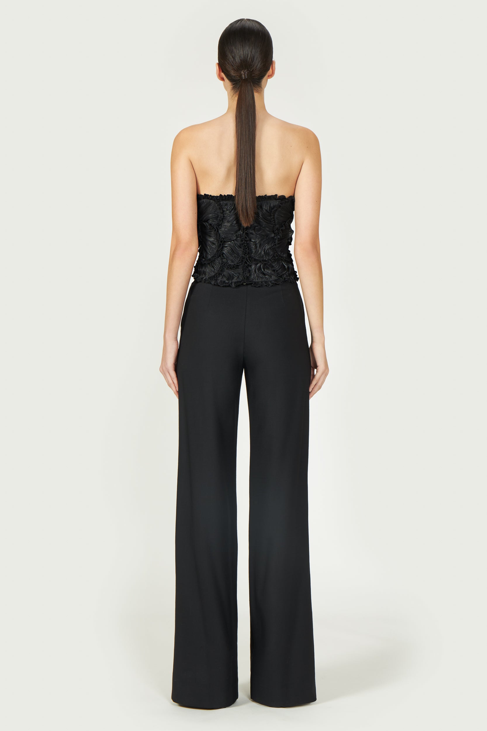 Back view of Ezra Lurex Georgette Bustier, showcasing a fitted silhouette with delicate ruffle details. A stylish black bustier from Resort 2025.