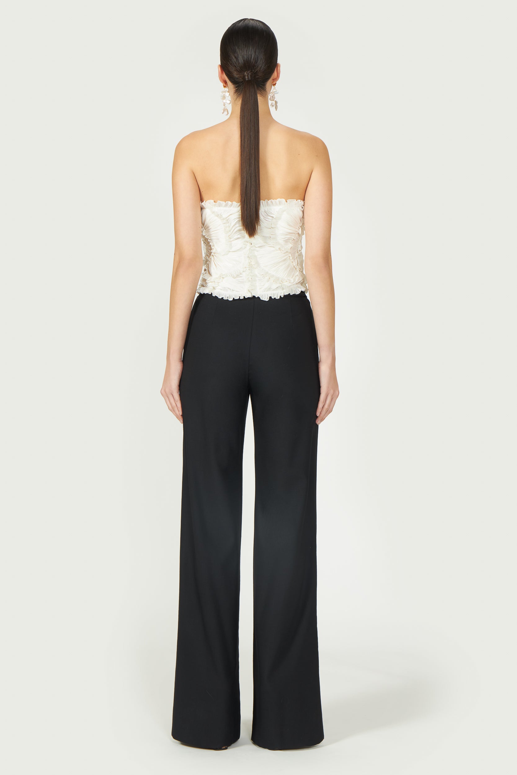 Back view of Ezra Lurex Georgette Bustier showcasing structured fit and delicate pleated details. A chic off-white strapless top for Resort 2025.