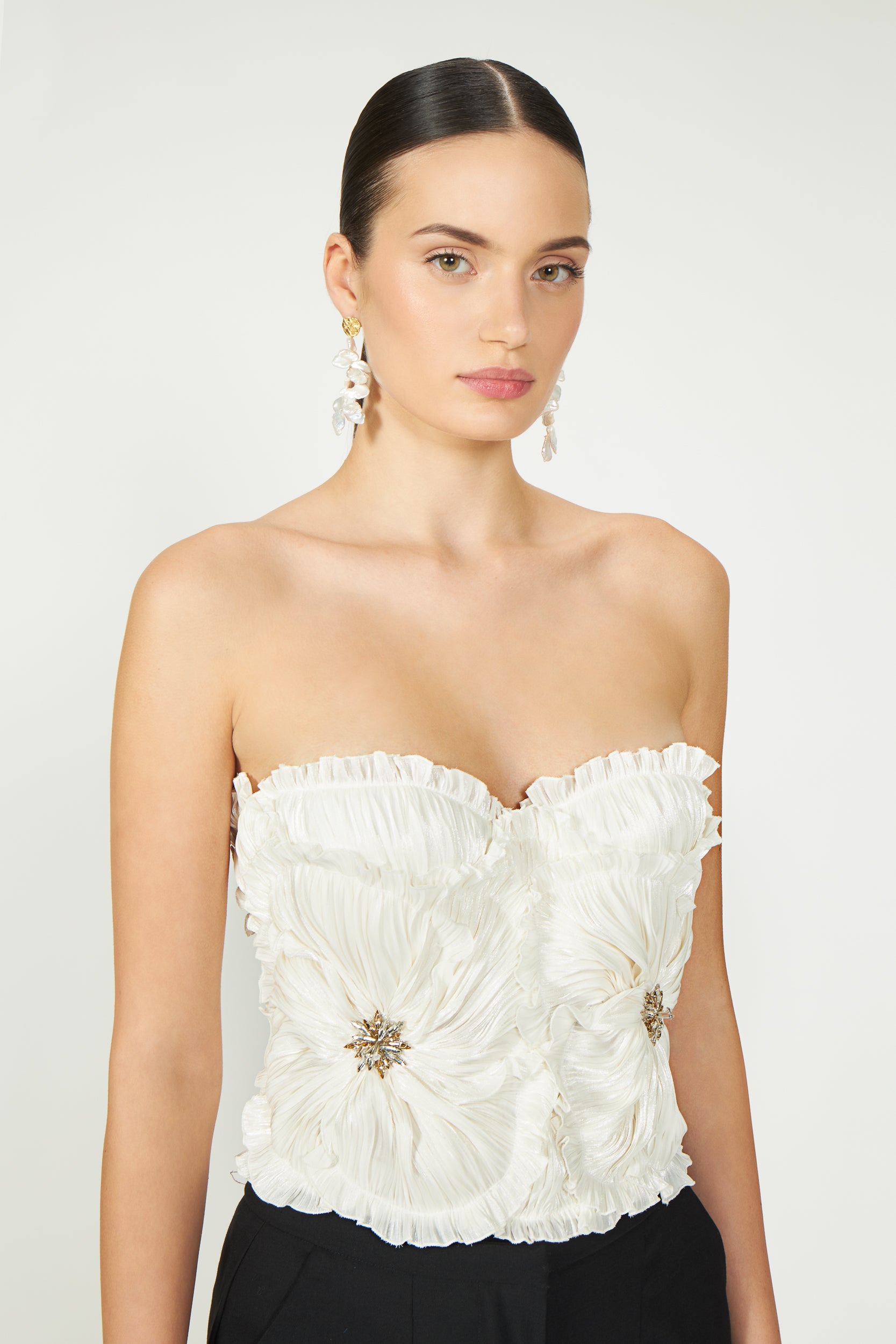 Ezra Lurex Georgette Bustier in off-white with floral pleated details and jeweled embellishments. Strapless design, perfect for Resort 2025 styling.