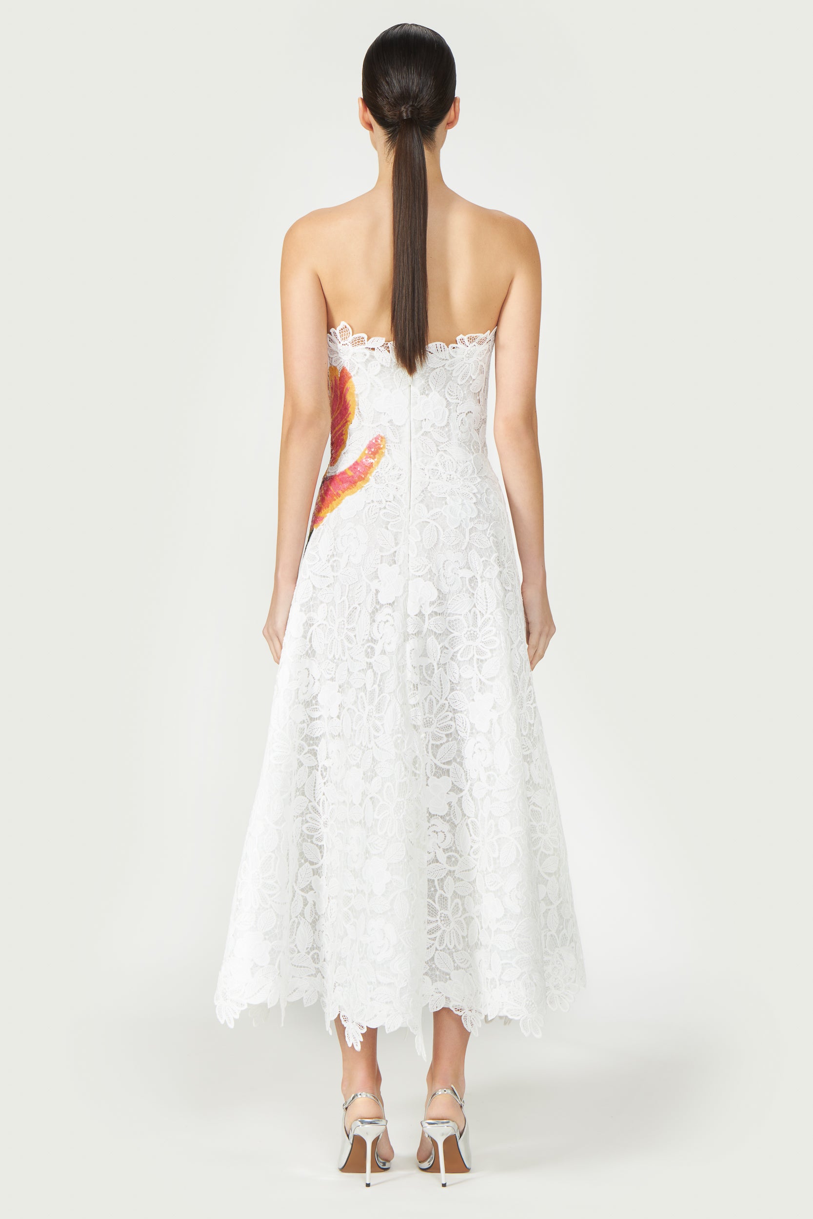 Back view of Mariela Corded Lace Gown featuring a strapless silhouette, delicate lace pattern, and a flowing A-line skirt. Ideal for Resort 2025 and formal events.