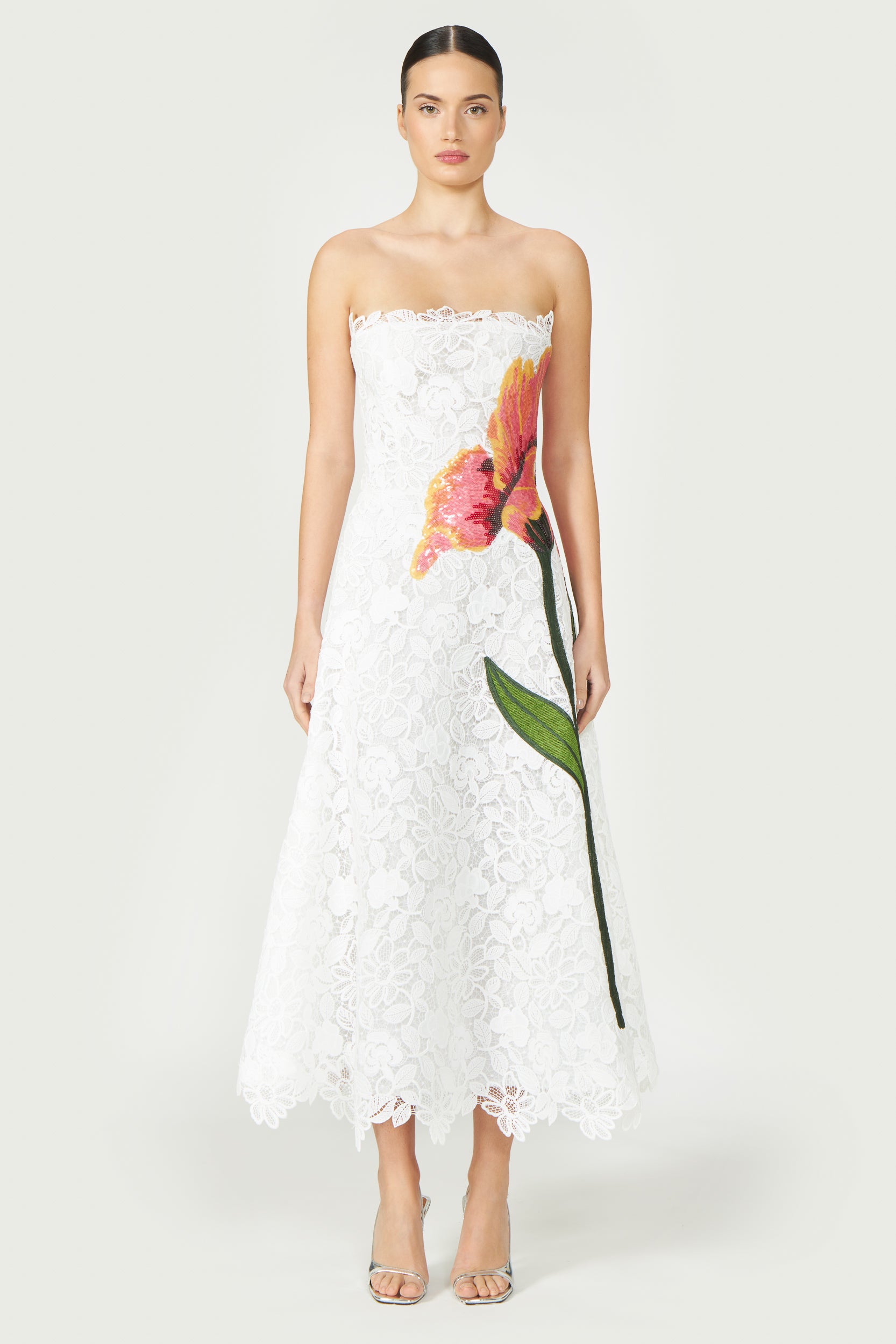 Mariela Corded Lace Gown in off-white with floral sequin embroidery, strapless design, and scalloped lace hem. Perfect for Resort 2025 and special occasions.