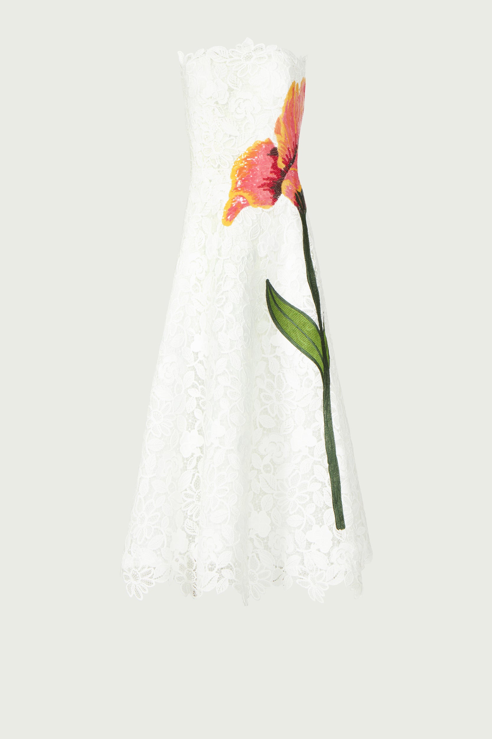 Mariela Corded Lace Gown displayed against a neutral background, highlighting its off-white lace fabric and bold floral embroidery. A refined choice for elegant occasions.