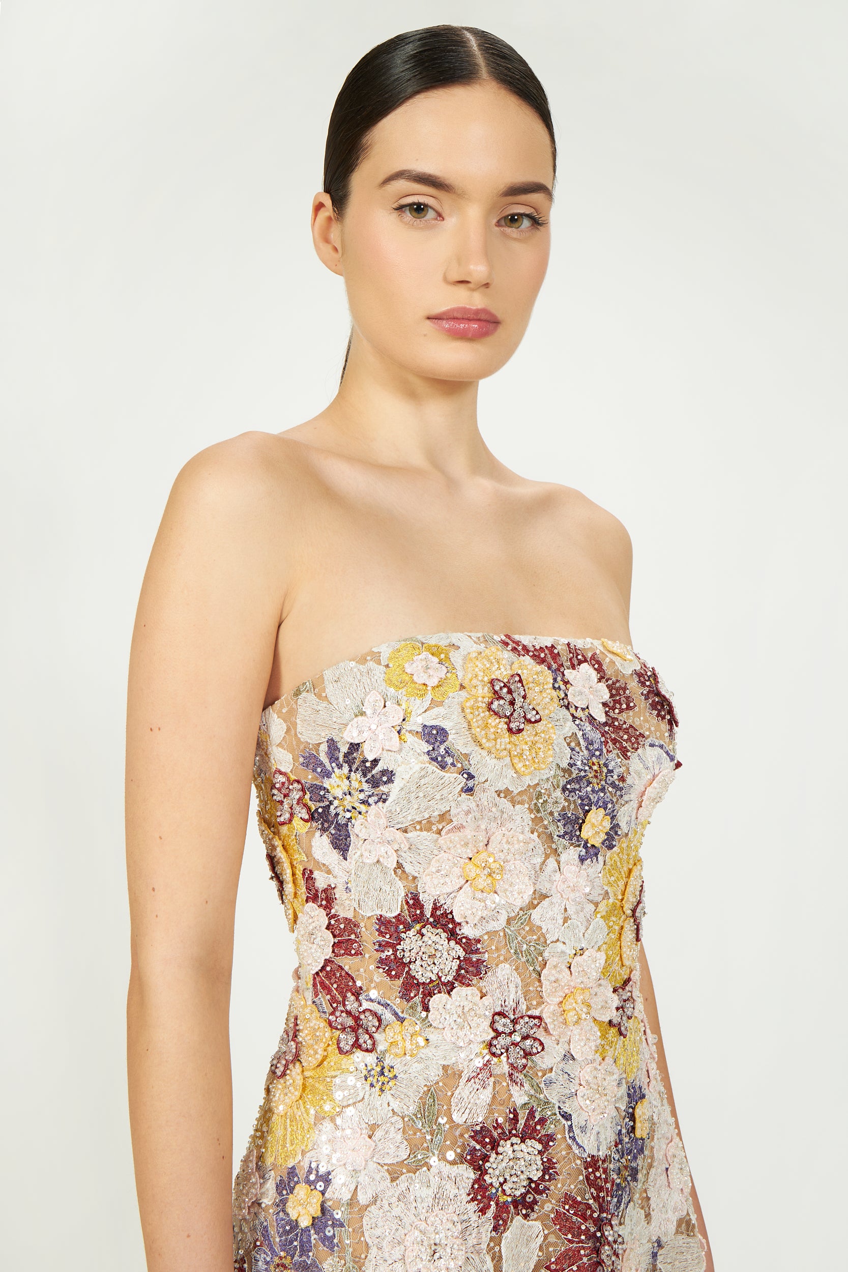 Strapless floral embroidered gown in pastel shades with intricate beadwork and sheer detailing, elegant and luxurious design.