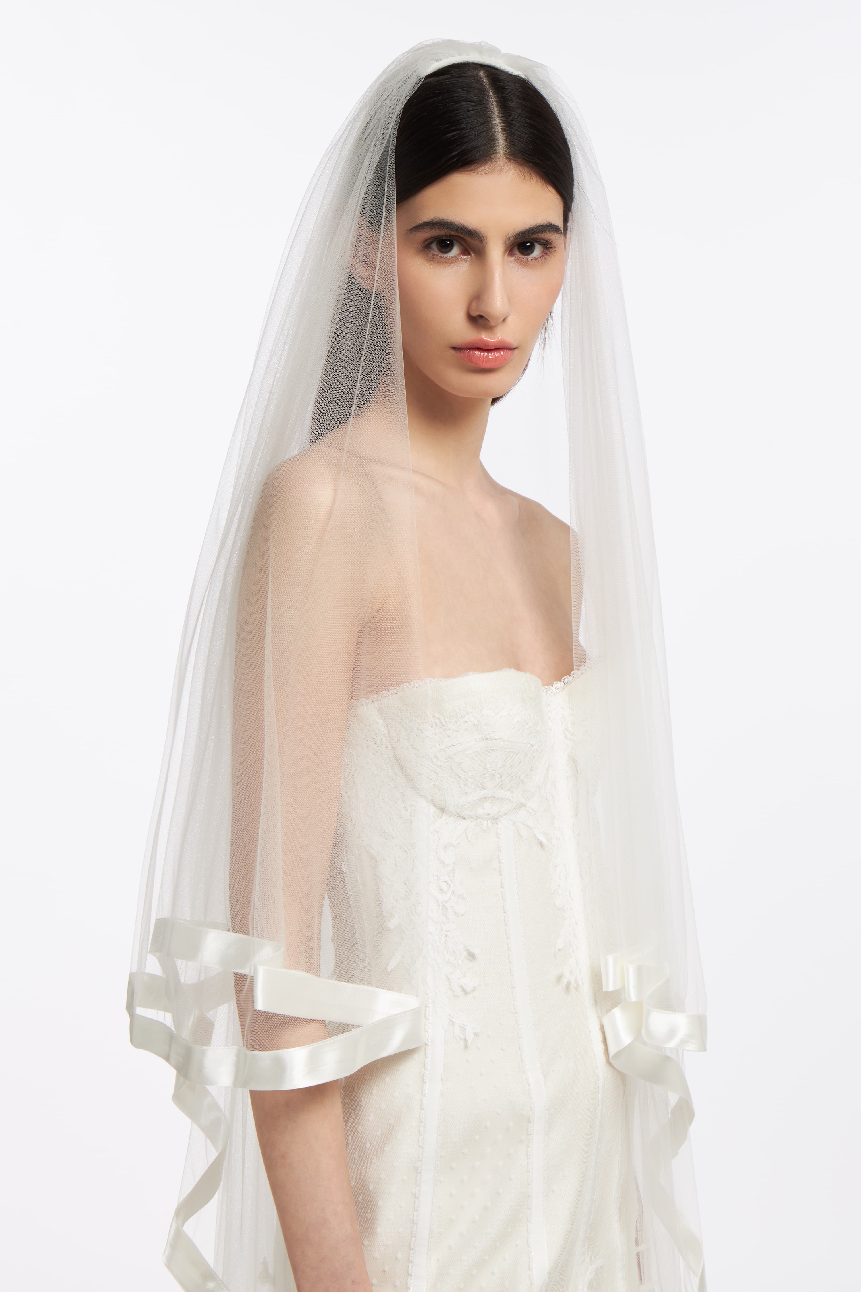 Elegant Satin French Tulle Veil with satin trim, perfect for bridal wear. Lightweight and sheer, complementing wedding gowns beautifully.