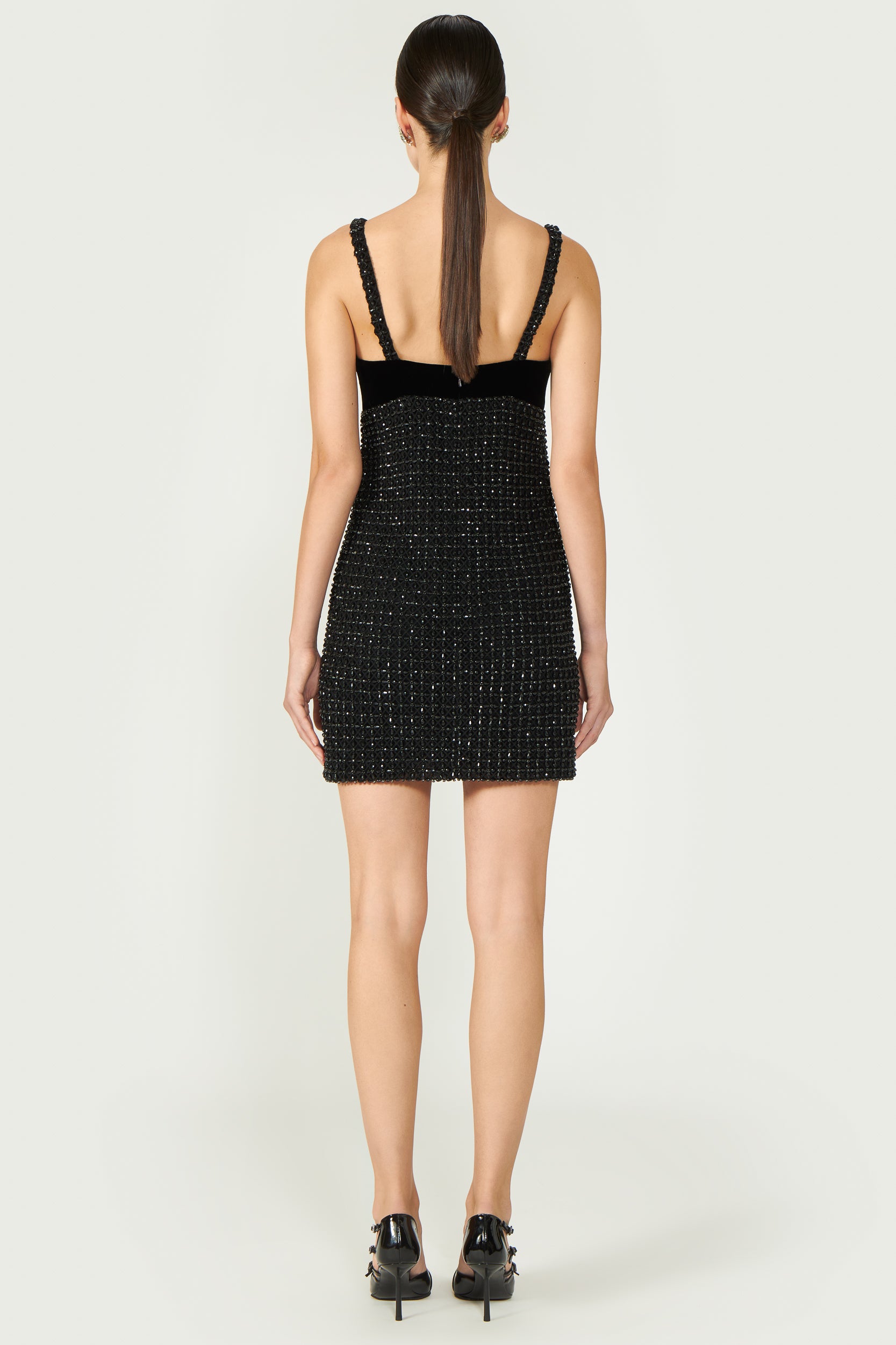 Back view of Aphra Beaded Mini Dress, highlighting structured fit, velvet panel, and beaded detailing. A sophisticated black mini dress for special occasions.