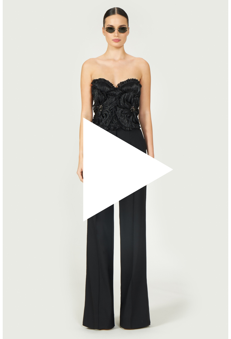 Video thumbnail featuring Ezra Lurex Georgette Bustier, a black strapless top with floral ruffle details. Watch for styling inspiration from Resort 2025.