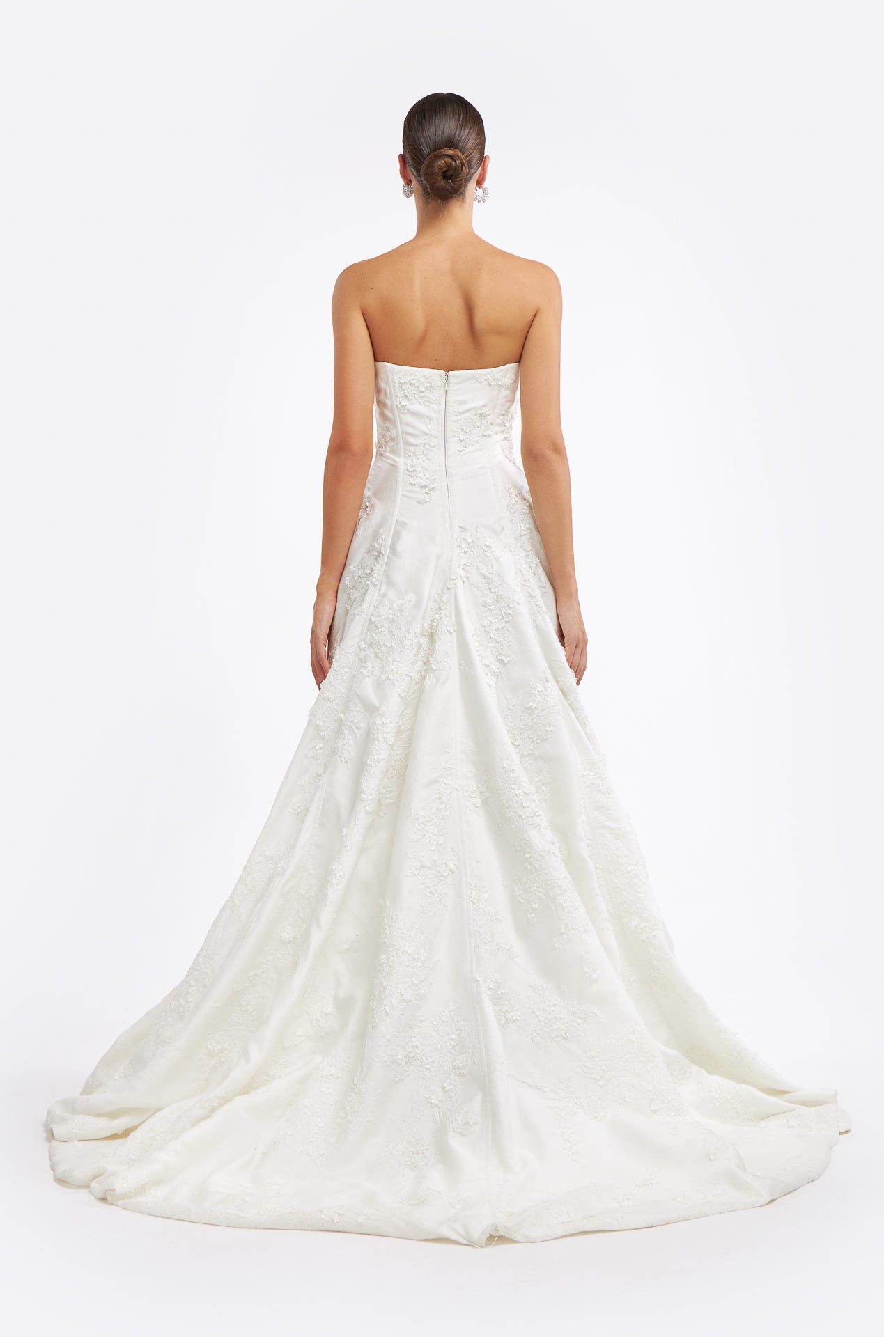Back view of the Krinna Jacquard Strapless Gown highlighting a flowing train and corset-style bodice, ideal for a classic wedding ensemble.