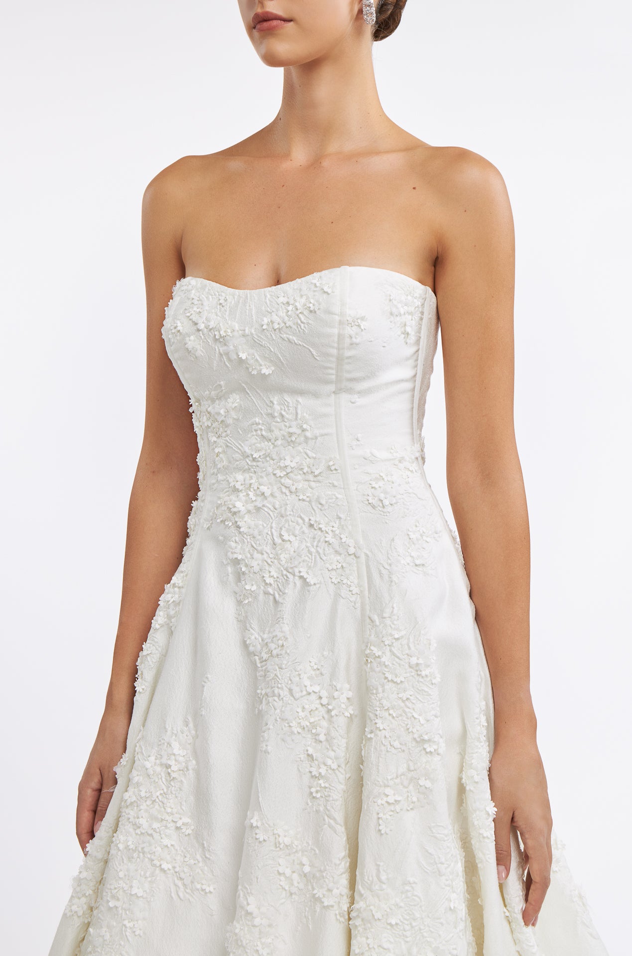 Close-up of the Krinna Jacquard Strapless Gown showcasing delicate floral embroidery and structured bodice for a sophisticated bridal style.