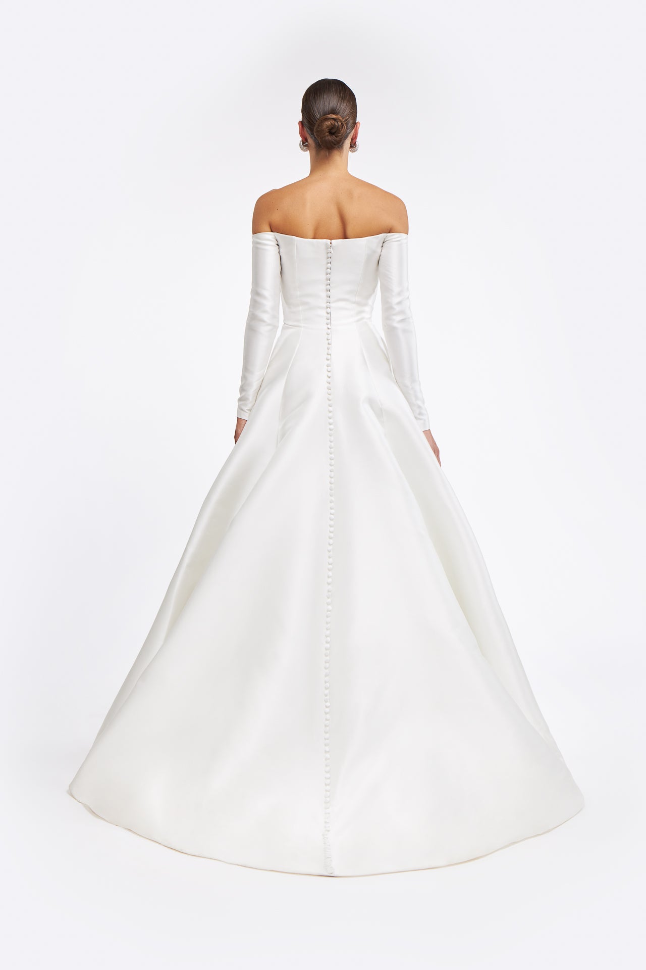 Rear view of the Berenice Off-shoulder Mikado Gown highlighting its elegant buttoned back and flowing train. A classic wedding dress for modern brides.