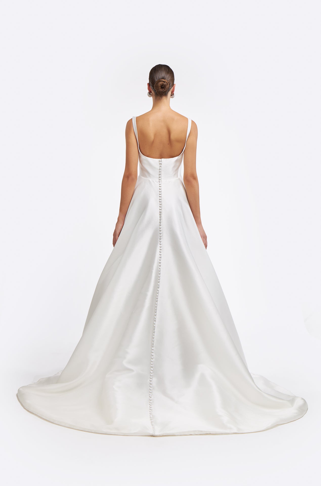 Back view of the Damara Mikado Gown featuring a low scoop back and elegant button detailing along the train. A graceful and refined bridal dress.
