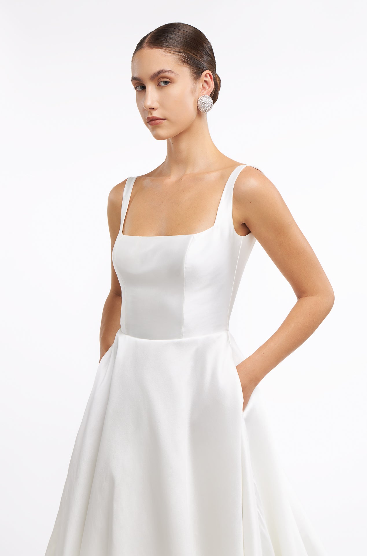 Close-up of the Damara Mikado Gown showcasing its structured bodice, square neckline, and delicate straps. A sophisticated choice for modern brides.
