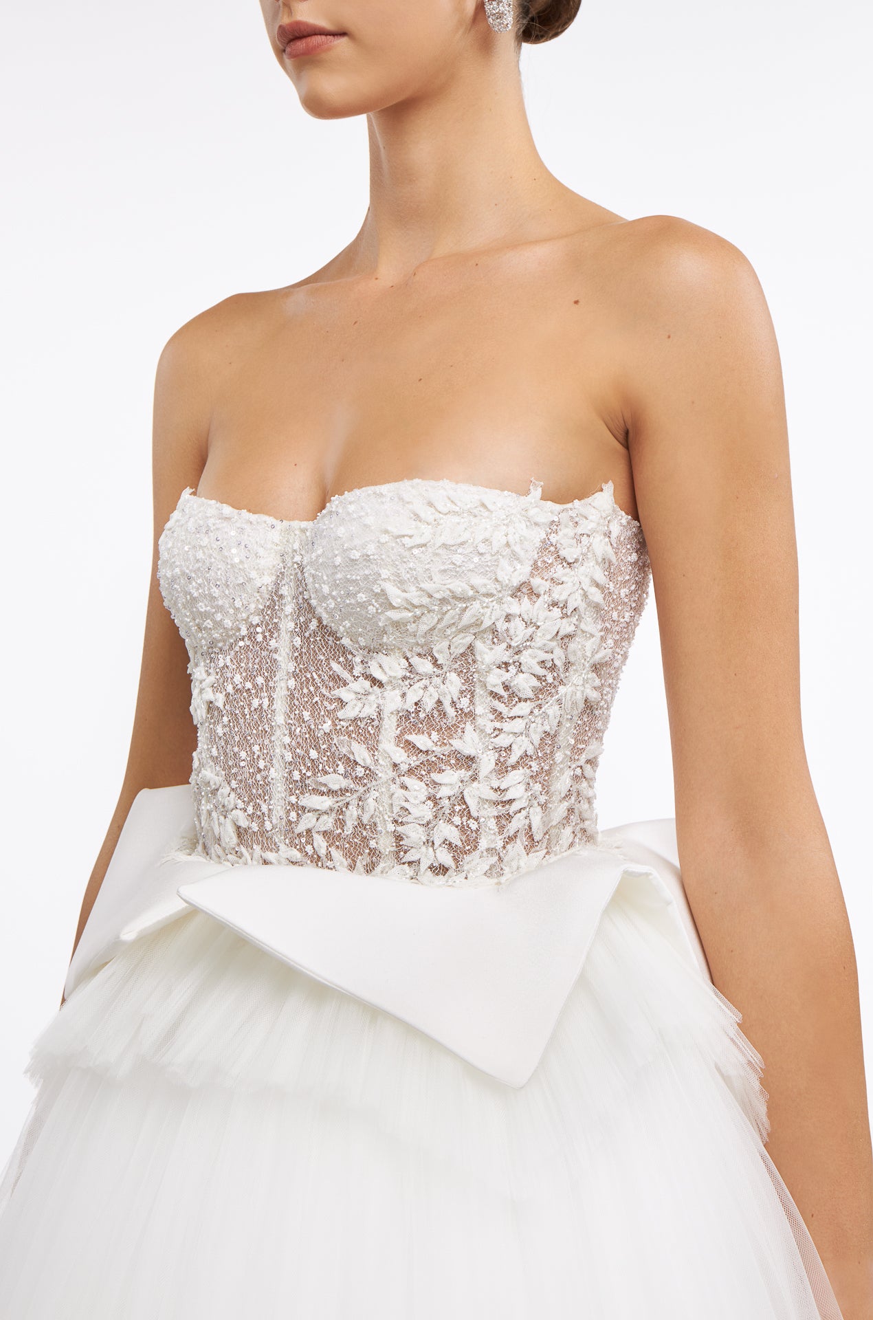 Close-up of the Emmelia French Tulle Gown’s intricate strapless corset bodice with floral lace detailing. A statement bridal look for Fall 2025.