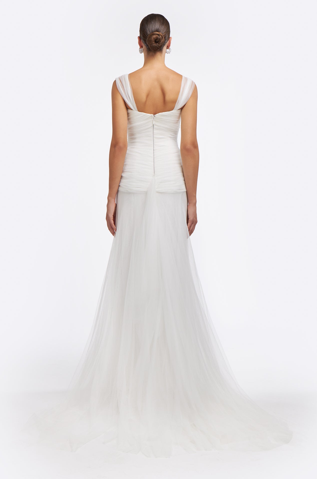 Back view of the Neda Knotted French Tulle Gown with sheer straps, ruched bodice, and a flowing tulle train. A stunning wedding dress for modern brides.