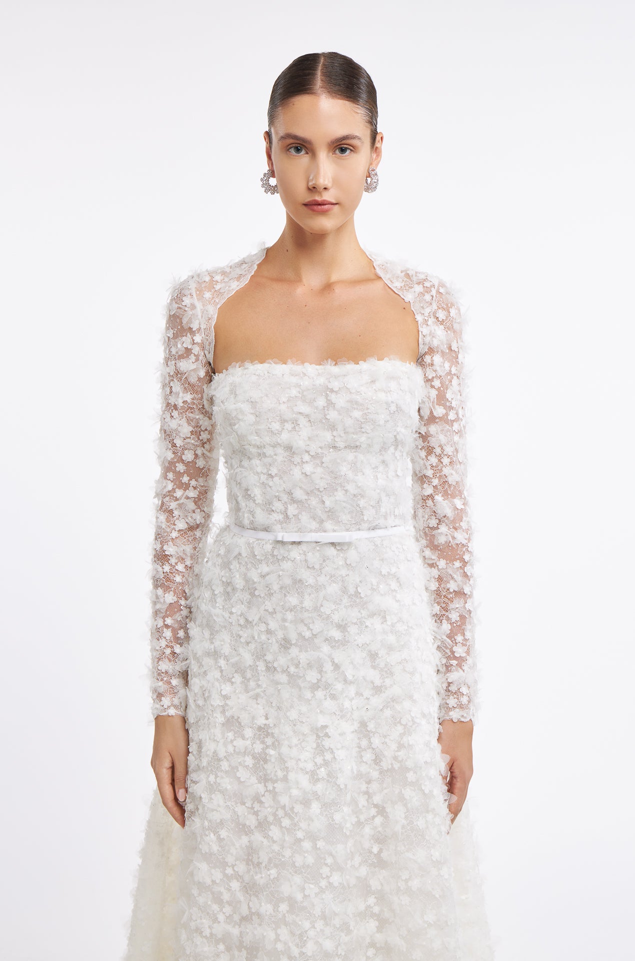 Fereniki Embroidered Lace Gown with detachable long-sleeve lace bolero. Floral appliqué detailing enhances the romantic bridal look.