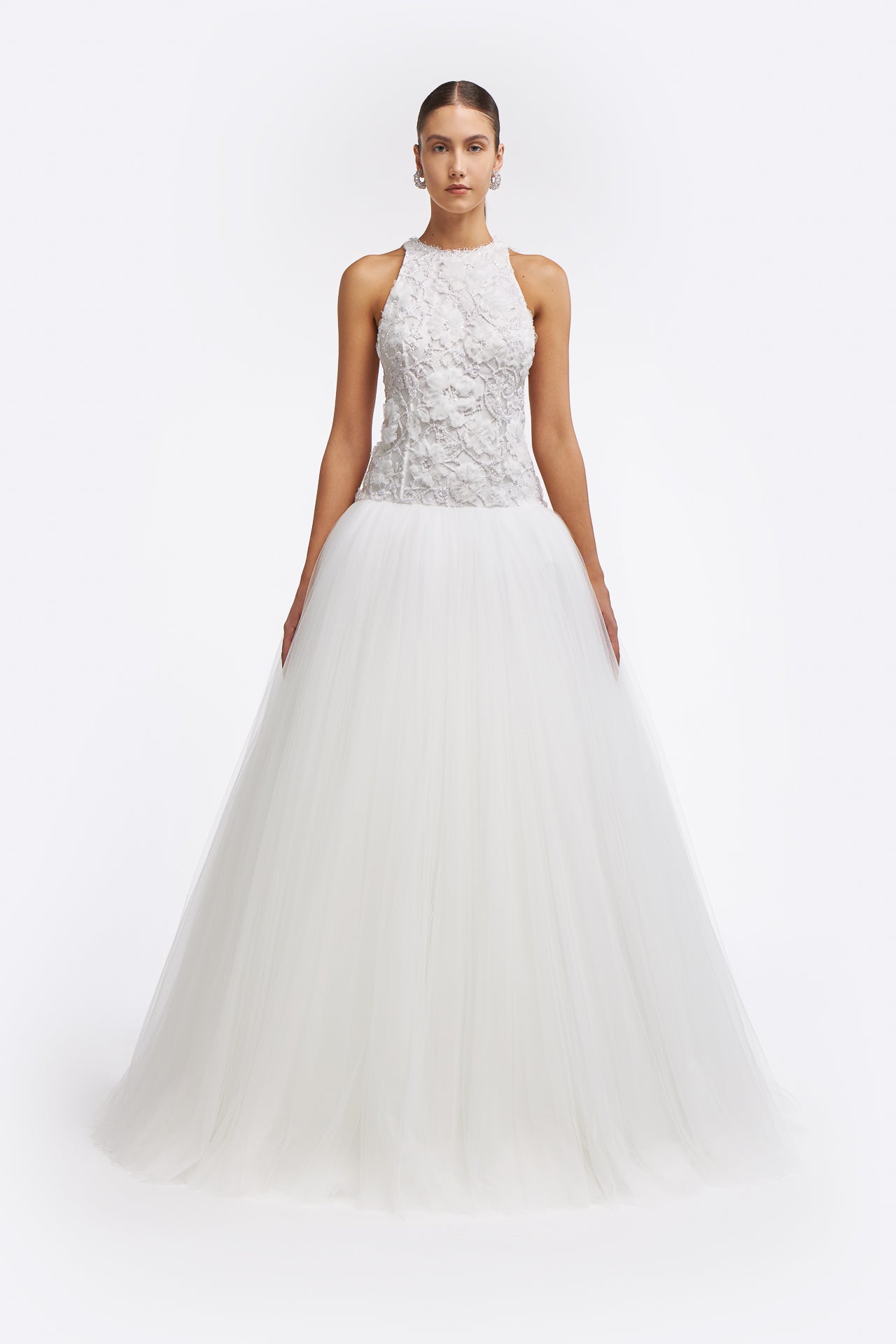 Chrisa Embellished Lace Gown featuring a halter neckline, floral lace bodice, and voluminous tulle skirt. A stunning bridal gown for Fall 2025 weddings.