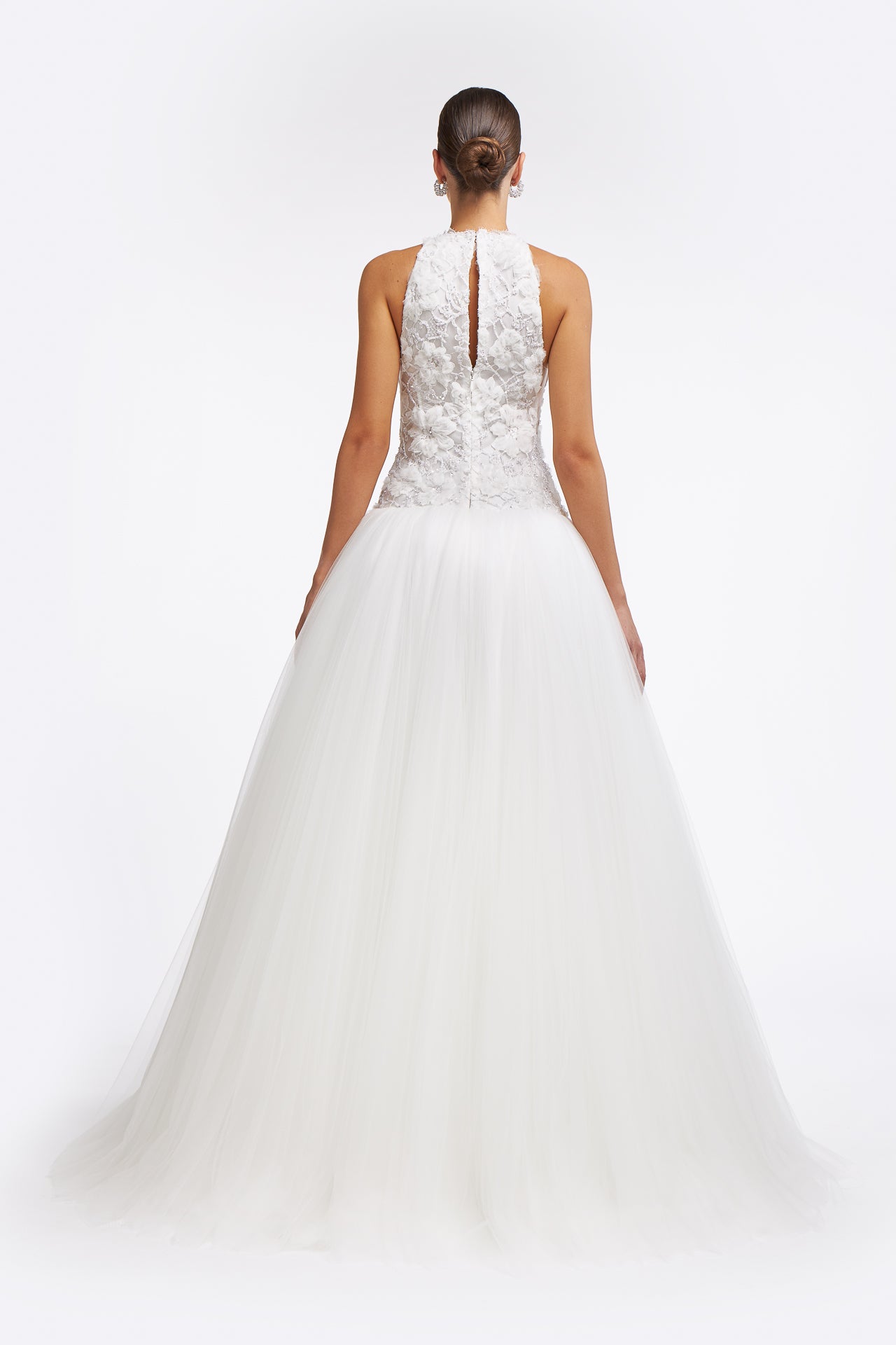 Back view of Chrisa Embellished Lace Gown with a keyhole closure and flowing tulle skirt. A timeless wedding dress for modern brides.