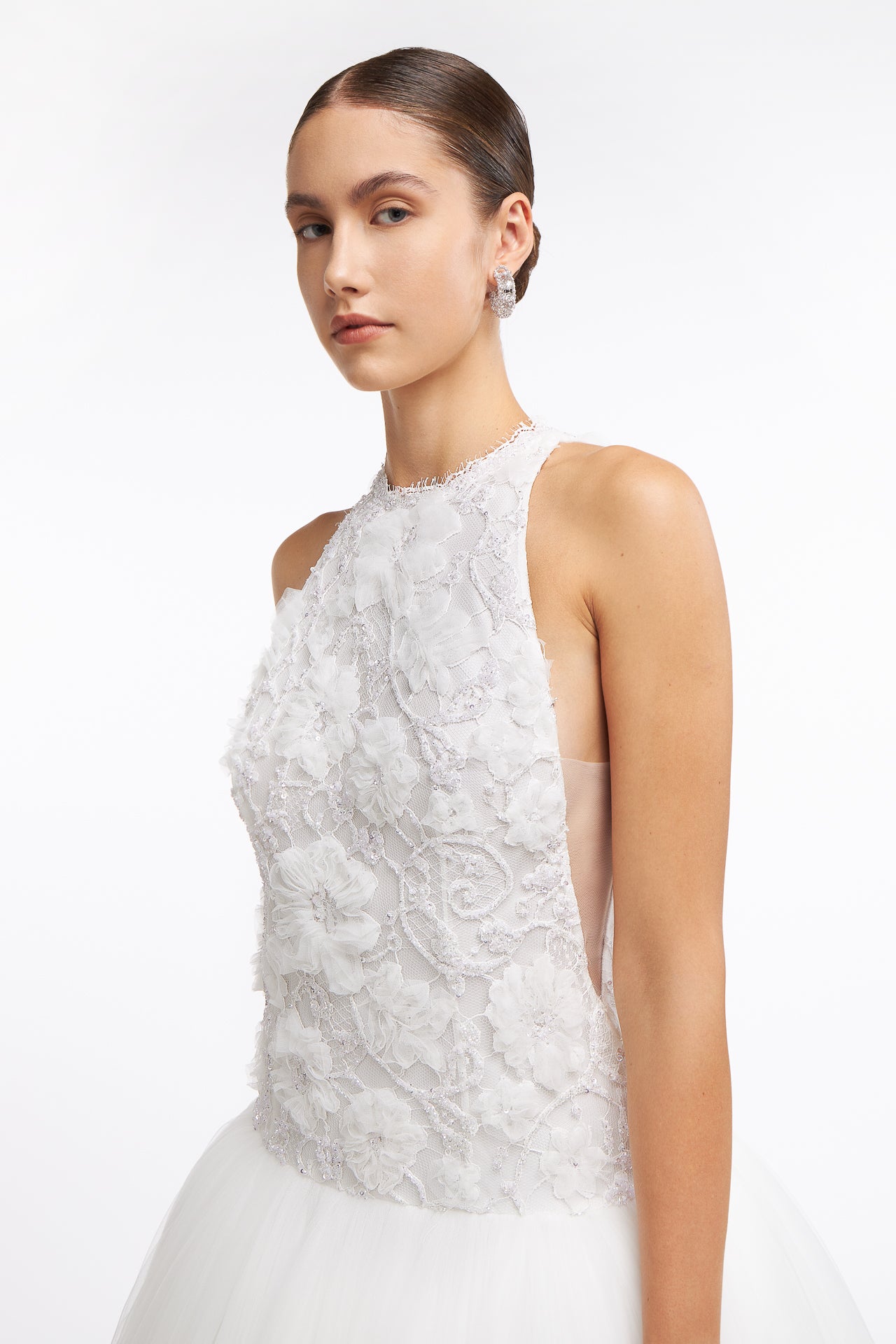 Close-up of Chrisa Embellished Lace Gown showcasing intricate floral lace detailing on the bodice. A perfect choice for elegant bridal looks.