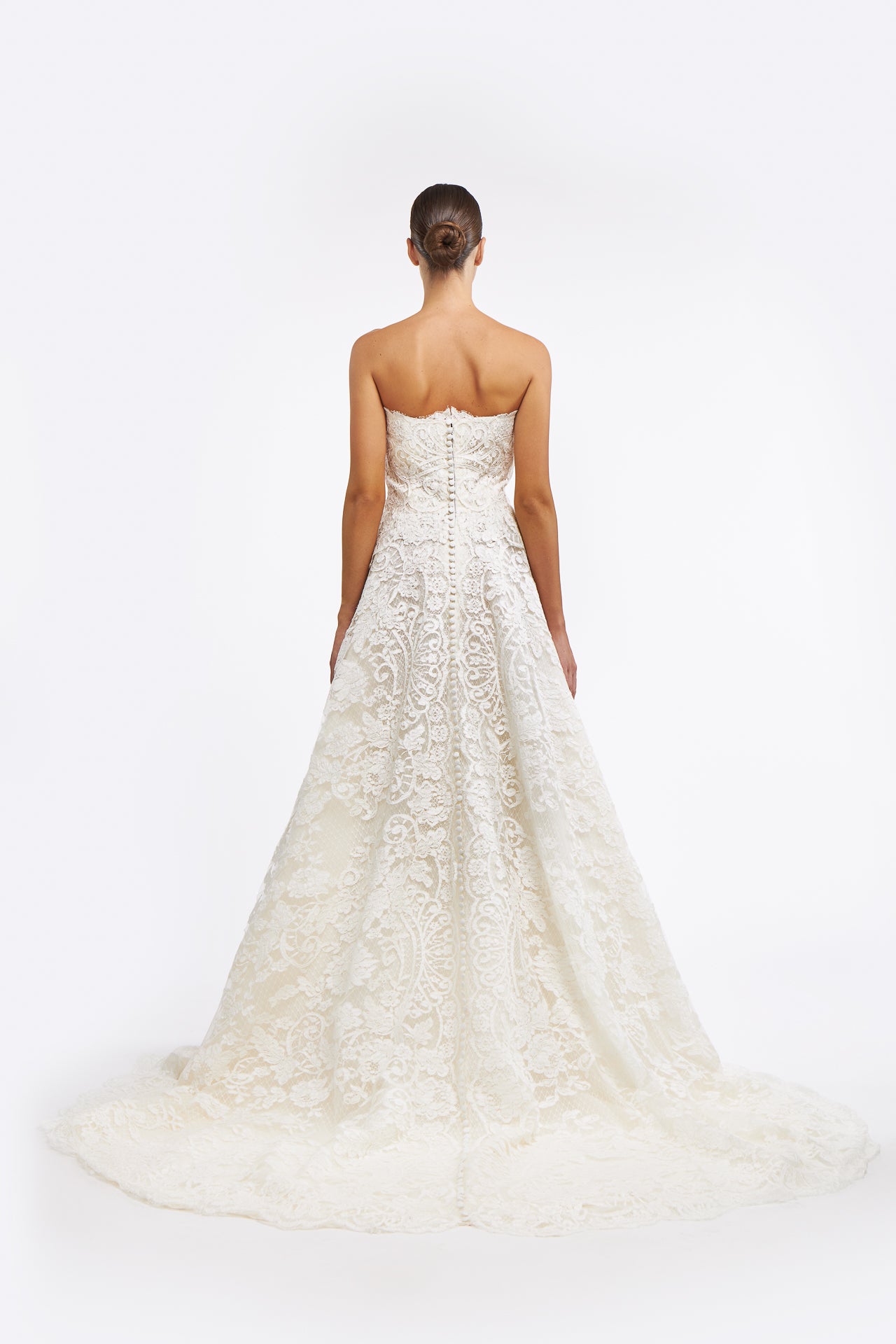 Back view of the Isolde Corded French Lace Gown with a flowing train and button-up closure, highlighting its classic bridal elegance.