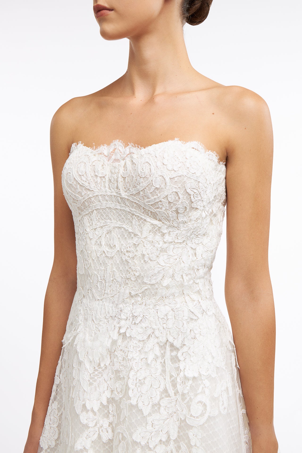Close-up of the Isolde Corded French Lace Gown showcasing delicate floral lace patterns and a structured bodice for an elegant wedding style.